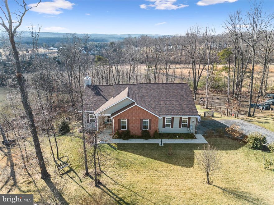 Beautiful One Level Home on 3 picturesque acres with no HOA.  Built in 2017 this home offers a contemporary open floor plan with all the living on one level plus a full unfinished basement with space for rooms and plumbing rough-in for an additional bathroom, PLUS a rough-in for wood-burning stove.  Gorgeous kitchen with an abundance of counter space & cabinetry is the heart of home.  Complete with Center Island and extended bar seating, stainless appliances, pantry & granite counters.  Adjacent dining space is ample with space for the largest gathering table.  Family room has wood burning fireplace with beautiful mantle.  There is a separate den with doors for privacy.  Perfect for home office.  ** Comcast Internet Available**    All spaces flow into one another and are highlighted with beautiful windows, natural light and views.   Private Primary Suite is tucked away for peace and quite with its own luxurious bath.  Located at the rear of home, these spaces enjoy lovely views as well.  Main level is host to 2 additional bedrooms and another full bath.  Make your move to the expansive deck to enjoy the great outdoors.   Running from one end of the house to the other this beautiful and solid deck  is the place you'll spend summer evenings and early mornings to celebrate the day.  For the grill master there is an installed gas line for your gas grill.   Deck stairs lead partially fenced yard.  Land offers trees and lush landscaping.   A gardeners dream.  Located just 8.5 miles from Winchester Medical Center, Grocery,  Restaurants, Stores.  This home is nestled in the country and just minutes from town conveniences.  ****Seller requires immediate settlement and  post settlement occupancy****  Propane serves gas stove & gas grill line located on deck.   Recent updates include deck freshly painted, Stairwell painted and stairs sealed, Main level rooms Freshly painted .  New water softener 2024.   Rough in for full bath and woodstove in basement