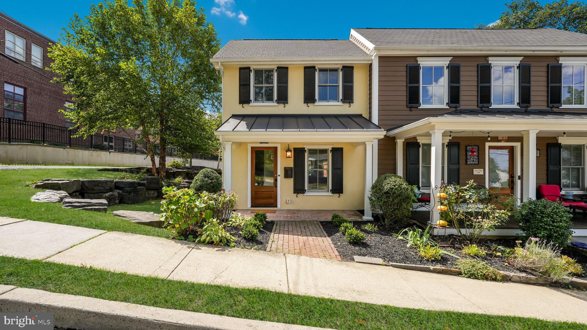 Welcome to this beautifully expanded and remodeled 1856 Borough twin, completely rebuilt in 2018 and offering the best of historic charm and modern convenience. Featuring an open floor plan and a premium in-town location, this 2-bedroom, 2.5-bath home shines with hardwood flooring throughout and abundant natural light. The inviting living and dining area showcases a Mercer Tile gas fireplace, while the updated kitchen boasts stainless steel appliances, a farmhouse sink, and direct access to a rear slate patio overlooking the landscaped yard with stone retaining wall—an ideal spot for morning coffee or evening relaxation. Upstairs, you’ll find two bedrooms, a full hall bath with neutral finishes, and a convenient second-floor laundry. The spacious primary suite offers a vaulted ceiling, walk-in closet, and ensuite bath with dual vanity and walk-in shower. Completing the package, this home includes a private driveway and rear parking—rare for Borough living. All this just steps from shops, dining, and cultural attractions.