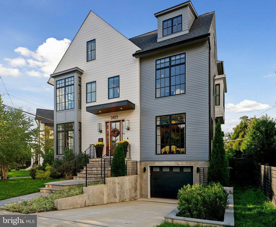 JUST LISTED! Newly built in 2022 by Griffin Head, one of Northern Virginia's premier custom builders, this spectacular home offers extraordinary contemporary living in the heart of Arlington's Lyon Village. Offering six spacious bedrooms and five and one-half luxurious baths, this home exudes meticulous attention to detail, and a luxurious, thoughtful design with exquisite details throughout. Spanning approximately 5,500 sq. ft. of interior living area, this property offers a desirable center hall floorplan, framed by a spacious dining room & study, opening to a dramatic great room with true chef's kitchen, including large center island, breakfast area, six burner gas range, Thermador appliances and oversized pantry. The property offers a well thought-out floorplan, with multiple bedroom areas and plentiful options for work from home areas, home gym, media room, den & large recreation room. Many of the finest materials were utilized for construction, including numerous custom details with extensive woodwork, luxurious tile, hardwood floors, expansive designer windows and ten foot ceiling heights. Additional features include a main level terrace & additional roof terrace, mudroom, and attached garage. The home has been further customized by the original owners to include many professional designer touches including paint, wall coverings and motorized window treatments. With an ideal location in Lyon Village, two blocks from Courthouse Metro & Whole Foods, and just minutes from Reagan National Airport and Downtown Washington, DC, this spectacular property is not to be missed!