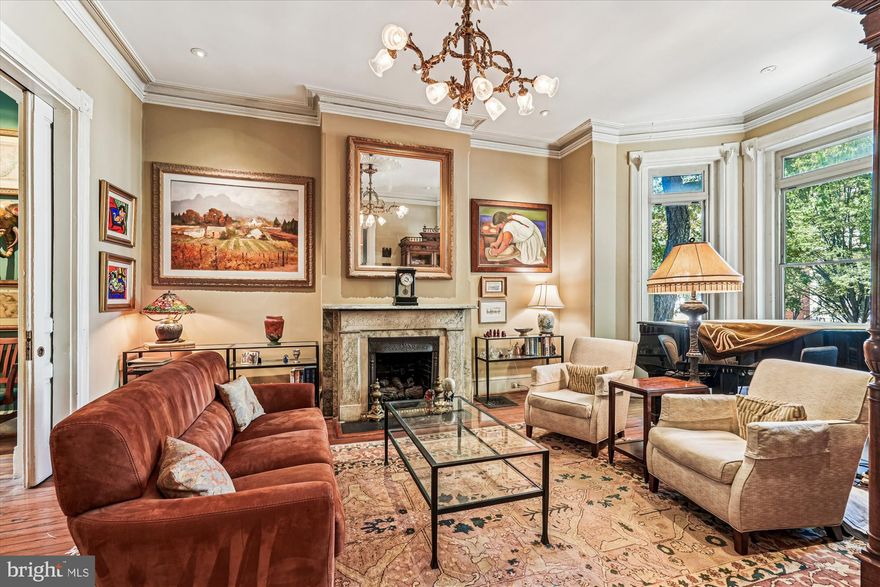 LOCATION! LOCATION! LOCATION! 1420 Q Street, NW, is an exceptional property located in the heart of historic Logan Circle. This 1880’s, 21.5’ wide, four level Eastlake Victorian offers an incredible opportunity to reside on the Best Block adjacent to the vibrant 14th Street Corridor. HIGHTLIGHTS: 6BRs/3.5BAs; 4,200 sq. ft.; Ceiling heights: 11’,10’ , 9’; Zoning Approved lot coverage expanded from 60% to 66.14%; Huge south and west facing deck off the Kitchen; 2 car parking; VACANT 1BR English Basement apartment (previously rented at $2,685/mo); Newer systems (HVAC, W/D, W/H, Kitchen appliances). The elegant proportions of this grand home offer a comfort and refinement only found in a truly exceptional property. The home is accented throughout with heart pine floors, plaster ceiling medallions and crown moldings. On the main level, two Eastlake marble mantels (with gas log sets), a north facing bay and two turn-of-the-century chandeliers add Gilded Age ambience for the Living and Dining Rooms. The Kitchen features an energy efficient LG refrigerator, Bosch D/W, vented commercial grade range hood, soft close cabinets, LED lighting, oversized S.S. deep sink, conveniently located pantry for extra storage and a Powder Room. The home’s entire second level is a Primary Bedroom Suite (See DOCUMENTS for architect designed re-imaged PBR/PBA). The spacious Bedroom features an arched sleeping alcove, crown moldings and heart pine floors. The Primary Bathroom features a jetted tub, dual sinks, separate shower, linen closet and updated Kohler faucets/showerhead. The middle Bedroom currently serves as a Den/Library and features a marble mantel (gas log set), and built-in bookcases. The hallway features custom-designed closet storage systems and new stacked high-efficiency Electrolux W/D. The third level features three Bedrooms. The multi-function rear BR could easily be used as a home office as it features built-in cherry cabinets, SS bar sink, granite counters and an under-counter refrigerator. The updated hall bathroom features heated Carrara marble floors, glass shower enclosure and linen closet. The one Bedroom English basement apartment’s living space features a gas fireplace, Kitchen w/ stacked Bosch W/D, gas furnace and 50-gallon water heater (both new in 2021), large BR with walk-in closet plus front and rear unit egress. Previously rented for $2,685 a month (utilities inclusive), and with a Certificate of Occupancy, it provides an attractive contribution to a Buyers’ monthly mortgage payment. The expansive main level south and west facing rear deck was designed with low maintenance Trex decking, red cedar privacy walls and stainless-steel cable railings. The stairs and blue stone paver pathway lead to two car parking and under-deck storage. In addition to the original cast iron railings, the 1880’s brick façade features black accent brick work with stepped brick cornice and slate windowsills. The HVAC for the main house and the rental unit were installed in 2021. With this incredible location, you can easily imagine living in the heart of vibrant Logan Circle, steps to award winning restaurants, theater, coffee shops and grocery stores (Whole Foods, Trader Joe’s).