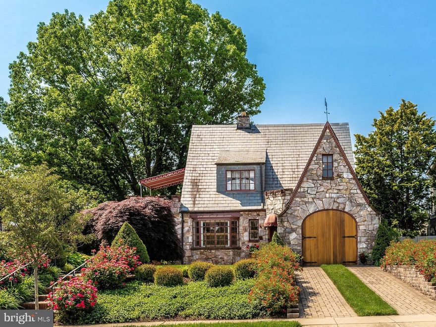 One of the most adored homes along the edges of Baker Park, oozing with storybook charm and loaded with upgrades. Professionally landscaped and maintained with knockout roses lining the stone walkway and driveway. The arched African Mahogany wood garage door would be the focal point of this home if the rest of the home weren’t as equally eye catching . 402 W Second Street is bursting with inviting color. Inside, the original refinished wood floors grace the living room, dining room and bedrooms. Freshly painted windows allow this beautifully natural lit home to glow. The windows of the sunroom open out into the garden. The kitchen is a dream to look at but even more fun to cook in. Remodeled with painted cherry cabinets that take full advantage of the space and includes an ILVE Italian gas range and hood, sub-zero refrigerator and European rise and fall pendant lights. A Bosch dishwasher does the job of cleaning up and the sharp microwave simplifies meals but the heated floors make the kitchen a cozy space to work or relax. The kitchen opens to the spectacular backyard with a raised bed potager garden that includes flowering shrubs, a vegetable garden, 3 fruit trees and is graced by an antique stone statue and the relaxing sights and sounds of a fish pond. Smartly designed with a beautiful outdoor living space – the patio is covered with a pergola that has an electric, retractable awning for maximum comfort. Upstairs are 3 bedrooms and a den, all with wood floors.  The primary bedroom has a cedar closet, access to the walk-up attic and private access to the balcony. Enjoy views of the neighborhood while lounging under the awning. The lower level was refinished in 2019 to include a family room with luxury vinyl plank flooring, an exercise room and full bath with steam shower. All that Baker Park and Downtown Frederick have to offer are just steps from your front door. Come fall in love!