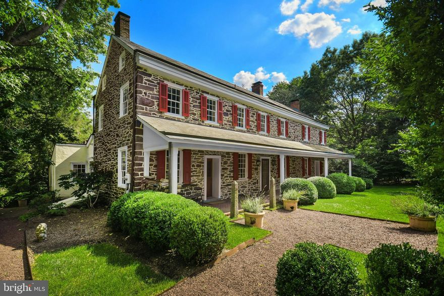 A magical living experience in the Bucks County countryside, this 1790s stone farmhouse on 13.6 acres offers vintage architectural elements updated with the modern amenities one would expect for luxe country living. Thoughtful additions and renovations over the years have created an elegant and well-designed country estate without compare. 
      The original farmhouse boasts antique accoutrements and architectural details such as exposed stone walls, 5 fireplaces, random width chestnut floors, beamed ceilings, period moldings and hardware, and deep windows with antique glass. Large covered porches in front and back feature herringbone brick, setting the stage for a home that seamlessly blends 19th-century soul with modern amenities. This stunningly restored and updated home  is a masterclass in combining historic charm with sophisticated living.  A recent addition includes a sunny, oversized kitchen with vaulted ceiling, clever built-in storage, and a breakfast nook that looks out over the idyllic countryside. A den, living room and guest suite with bath complete the first floor. Upstairs, the primary suite includes a newly refurbished bath and stylish dressing room/walk-in closet with built-in storage, and access to the balcony for enjoying a morning coffee or evening cocktail accompanied by long-distance views. Completing the upper floors are three additional bedrooms and a hall bath.
     The swimming pool, dramatically positioned amidst long-distance vistas, offers a pool house with bar and sound system. Herringbone brick decking around the pool is set off by split rail fencing and manicured box hedges, creating a sophisticated space for parties, guests, or quiet evenings with family. Near the main house is a circa 1790 stone summer kitchen with 2 pizza ovens and Argentinian wood grill. A detached garage provides covered parking, while a sunny and spacious 2nd floor serves as artist’s loft or private office space, complete with wood stove and half bath.
     Multipurpose buildings are perfectly positioned amidst the rolling acreage, overlooking vistas of manicured horse pastures. The stone bank barn, breathtakingly restored, provides an amazing vaulted space for entertaining in large numbers, as well as a media loft, studio space, and caterer’s kitchen. Adjoining this multipurpose space are guest quarters with a kitchenette, two full baths, and a private balcony. 
     Equestrian facilities include a well appointed 5-stall stable and heated tack room with built-in storage. An outdoor arena and 2 fenced pastures blend seamlessly into the thoughtfully landscaped acreage, accented with herb, vegetable, and rose gardens. 
     A rare mix of secluded tranquility and easy access to nearby towns, Windhorse Farm is just 90 minutes to Manhattan and under an hour to Philadelphia.