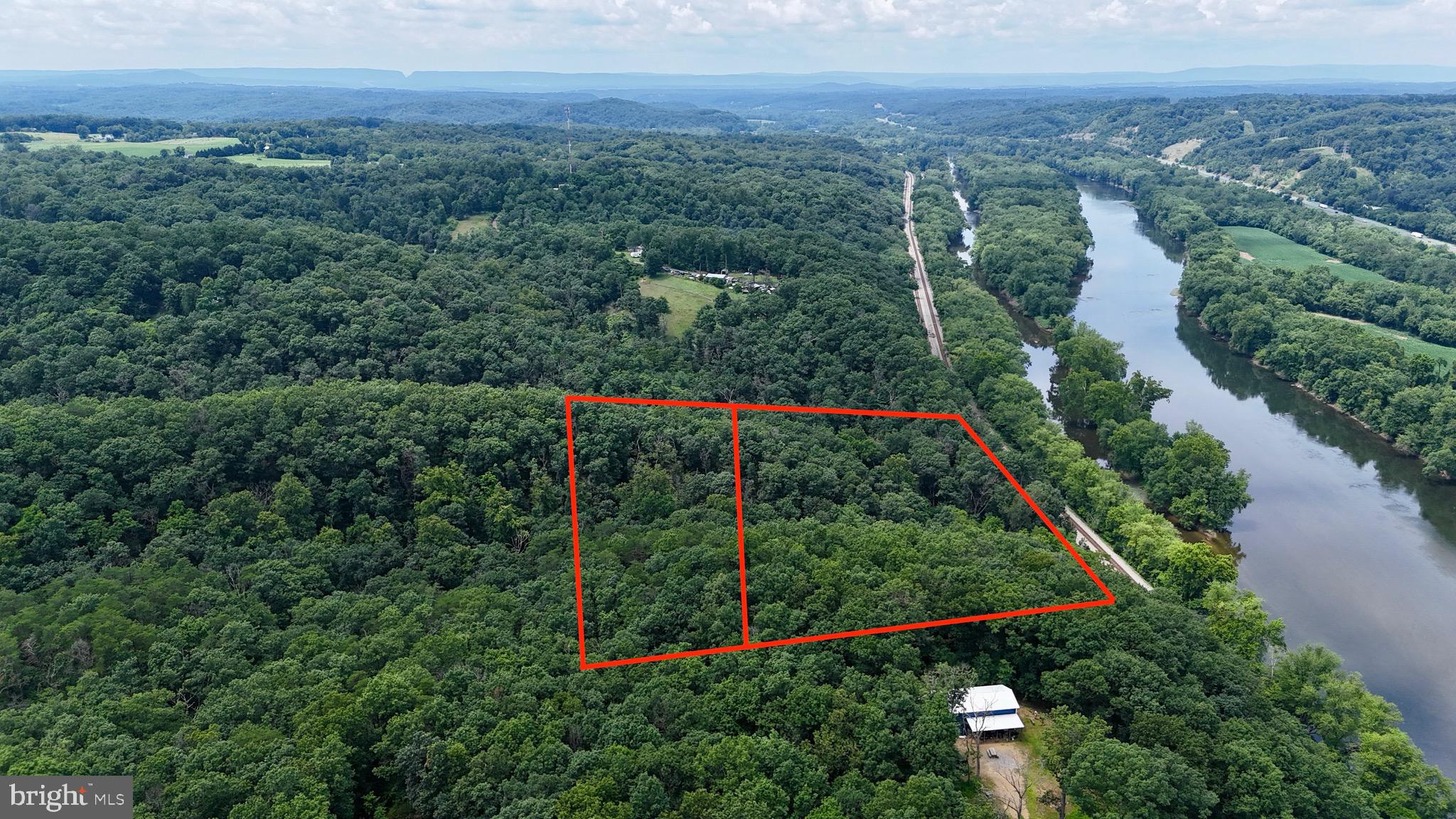 Looking for a view that takes your breath away? This may just be the one!
Don’t miss your chance to own 13.65 acres across two lots in the mountains of Morgan County, just a short walk to the Potomac River. Lot 7 sits high on the ridge with a sloped terrain that opens up to unbelievable panoramic views—cut a few trees and enjoy miles of scenery from your future porch, deck, or firepit.
Whether you’re dreaming of a weekend retreat, full-time cabin, or a place to immerse yourself in wildlife and peaceful surroundings, this property has the potential to deliver.
Located about 30 minutes to Berkeley Springs and Cacapon State Park, and under 2 hours from DC and Baltimore, this location offers both seclusion and accessibility.
Please note: Property is accessed via a right-of-way on Yeargin Trail - Do not visit without licensed agent