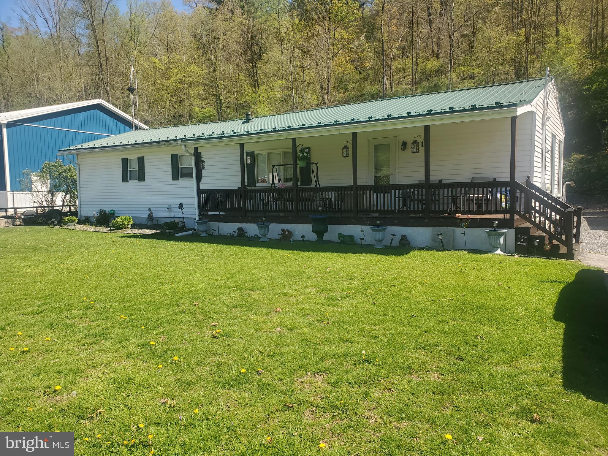 This property used to be a 12x60 Mobile Home, now it has been added onto with a large addition. The total Interior and Exterior are new. This home features a covered Front porch, Large rear Deck with Hot Tub.
One Car Garage with Door Lifter and Solar Panel Lighting System. Workshop fully insulated with Light and Electric. Garden Shed for additional storage. Interior has a U-Shaped Kitchen with Handmade Cabinets, Refrigerator less than a year old. Dining Room with 14 Foot Cathedral Ceiling and Ceiling Fans. Bedroom 2 remodeled with new Drywall, Paint and New Window. Owner Bedroom with attached Full Bath. Home Office has Handmade built in Desk and adjustable shelving. This Home could be Your's to enjoy the location of Country Living with a Yard overlooking trees. Call Office for key Information.