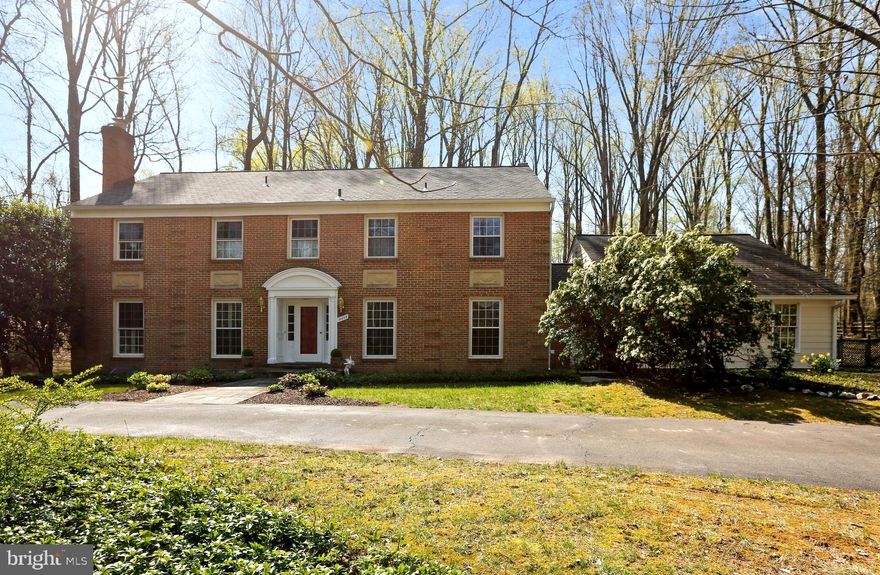 WELCOME HOME - A handsome traditional home with contemporary vibe lovingly maintained by its original owners on one of the prettiest streets in close-in Potomac.  The circular driveway sets the tone - wide flagstone walkway to front door - foyer, recessed lighting, charming powder room with wall sconce, guest closet and curved staircase  - LR with shutters, wood-burning fireplace, recessed lighting in living room, dining room, family room. Den/office with wet bar (currently houses the printer) bookshelves, cabinets and bar - lights and cabinet. Family room - fireplace flanked by bookcases with cabinets is expanded with a Pella sunroom.  Both sunroom doors lead to flagstone patio. Kitchen with hardwood floors, Corian counters, recessed lights - pantry - sliding door to patio - kitchen has counter as well as table space - Large dining room has French doors to deck. Laundry room on main level  and leads to 2 car garage with attic storage. Upper level: Primary suite - corner bedroom - 3 closets (one walk-in, chandelier, double sinks with fabulous lighting, separate room with oversize shower with glass door and private commode. Adjacent is optional 5th bedroom - currently used as expanded closet with mirrored wall concealing extra closet space. Bedrooms 2 and 3 privately located at end of hall with large bath with tub/shower (glass doors), separate linen closet - good closet space. Bedroom 4, at top of stairs - fitted closet, and 3rd full bath with tub/shower with glass door. Lower level: Tall ceilings painted black and track lighting to offer a high tech look - wet bar, storage and lounge area - Unfinished storage space and utility room. Exterior: 3rd car bay was converted into a veranda with 2 ceiling fans offer shade and comfort.  Gunite heated pool (propane heat) with automatic cover - partially fenced. Extensive stone walls - upper level ideal for playground. Incredible Potomac location! Potomac Village is so convenient to library, shopping including supermarkets, local food stores, restaurants, banks, post office and more. Near trails, hiking. Easy access to highways in and out of town. This is the place you want to be!