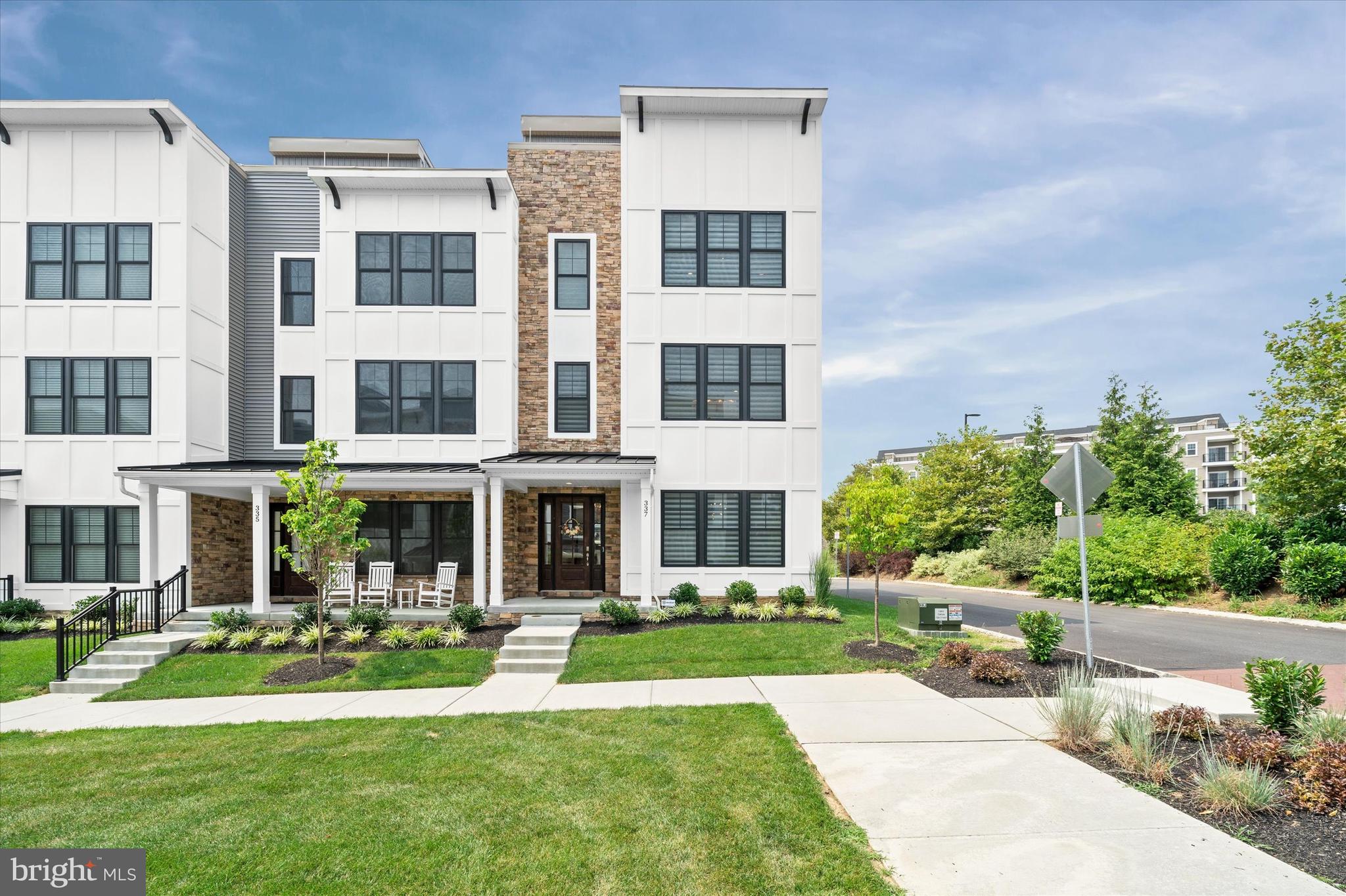 Luxury living at its finest in this move-in-ready end-unit townhome located in the highly sought after Towns at Newtown Walk. This exceptional 4-level residence offers 3 spacious bedrooms, 3.1 bathrooms, and every top-of-the-line upgrade imaginable.
Enjoy the convenience of a 4-stop wood-paneled elevator, a fully painted 2-car garage with epoxy flooring, and custom overhead storage. The entry level welcomes you with a stylish foyer and a versatile bedroom or home office complete with a full bathroom.
The second floor boasts a contemporary open-concept layout featuring a bright and airy family room and dining area. The gourmet kitchen is a chef’s dream—highlighted by an over sized island with wood accent siding, sleek quartz counter tops, a Café French-door refrigerator with gold trim, wall oven, wine cooler, and a custom wood range hood. The adjacent living room features a stunning linear gas fireplace with a tiled surround and built-in custom cabinetry.
Designer finishes throughout include upgraded cabinetry, Ferguson lighting fixtures, recessed lighting, brick tile feature walls on each landing, solid wood doors, and Hunter Douglas Pirouette blinds with remote-controlled blackout options.
The luxurious primary suite offers high-end designer wallpaper, a custom walk-in closet, and a spa-inspired en-suite bath with frame less glass shower doors and a rainfall shower head. A third bedroom with its own en-suite bath and custom walk-in closet completes this level.
The crown jewel of this home is the rooftop terrace—an entertainer’s paradise featuring an outdoor kitchen with a 36” gas grill and side burner, refrigerated cocktail bar with sink, mounted waterproof TV, Bose speaker system, Arhaus gas fire pit, and an electric pergola with integrated ceiling fan and lighting.
Located just steps from the brand new Village at Ellis Preserve Town Center, you’ll enjoy unmatched walkability to dining, shopping, and more. This is truly a rare opportunity to experience upscale, low-maintenance living in the heart of Newtown Square.
(Please refer to the included upgrade sheet for a full list of enhancements.)