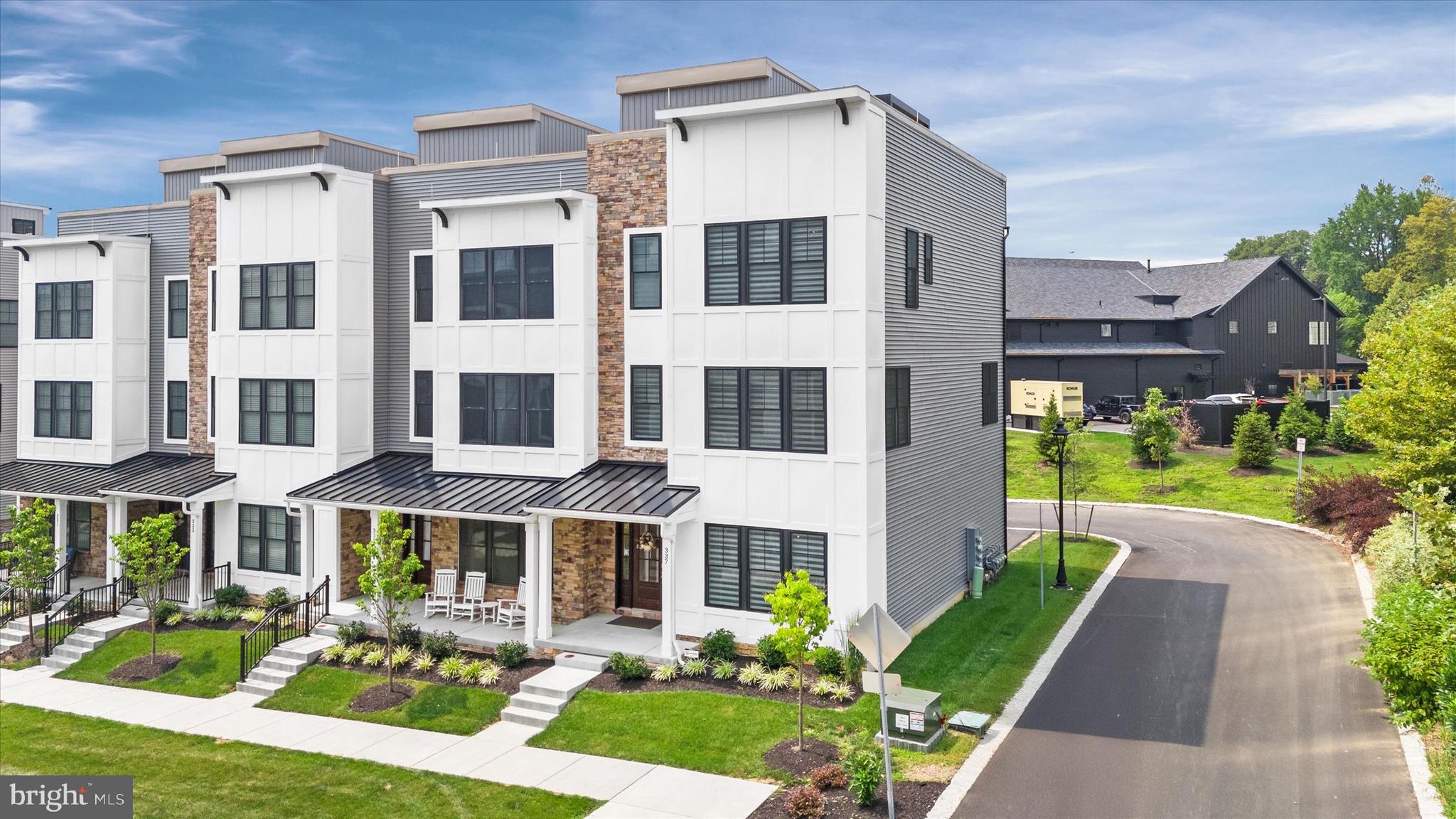 Luxury living at its finest in this move-in-ready end-unit townhome located in the highly sought after Towns at Newtown Walk. This exceptional 4-level residence offers 3 spacious bedrooms, 3.1 bathrooms, and every top-of-the-line upgrade imaginable.
Enjoy the convenience of a 4-stop wood-paneled elevator, a fully painted 2-car garage with epoxy flooring, and custom overhead storage. The entry level welcomes you with a stylish foyer and a versatile bedroom or home office complete with a full bathroom.
The second floor boasts a contemporary open-concept layout featuring a bright and airy family room and dining area. The gourmet kitchen is a chef’s dream—highlighted by an over sized island with wood accent siding, sleek quartz counter tops, a Café French-door refrigerator with gold trim, wall oven, wine cooler, and a custom wood range hood. The adjacent living room features a stunning linear gas fireplace with a tiled surround and built-in custom cabinetry.
Designer finishes throughout include upgraded cabinetry, Ferguson lighting fixtures, recessed lighting, brick tile feature walls on each landing, solid wood doors, and Hunter Douglas Pirouette blinds with remote-controlled blackout options.
The luxurious primary suite offers high-end designer wallpaper, a custom walk-in closet, and a spa-inspired en-suite bath with frame less glass shower doors and a rainfall shower head. A third bedroom with its own en-suite bath and custom walk-in closet completes this level.
The crown jewel of this home is the rooftop terrace—an entertainer’s paradise featuring an outdoor kitchen with a 36” gas grill and side burner, refrigerated cocktail bar with sink, mounted waterproof TV, Bose speaker system, Arhaus gas fire pit, and an electric pergola with integrated ceiling fan and lighting.
Located just steps from the brand new Village at Ellis Preserve Town Center, you’ll enjoy unmatched walkability to dining, shopping, and more. This is truly a rare opportunity to experience upscale, low-maintenance living in the heart of Newtown Square.
(Please refer to the included upgrade sheet for a full list of enhancements.)
