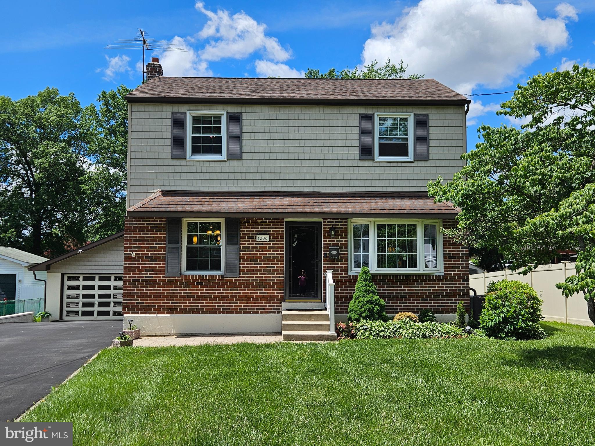 If you are looking for a spacious home with quality updates and a fantastic location then schedule your tour today! This lovingly cared for and updated home has so much value to offer. The curb appeal and exterior updates set the tone right from the start. Newer siding, and gutters with gutter guard makes for a virtually maintenance free exterior, while attractive doors and storm doors add beauty and energy efficiency. A wide and deep driveway plus a detached garage offers parking for 6+ cars. As you walk up to the front door a hardscape patio accentuates the entry way, and another covered hardscape patio behind the home enhances the back yard and rear entrance. When you enter the home in the living room the interior is bright and sunny thanks to a large picture window in the living room. The living room flows beautifully into the open concept dining room and kitchen, perfect for entertaining. The kitchen is absolutely stunning! Expansive granite countertops provide plenty of space for food prep, appliances, and bar seating as well. The layout is perfect for cooking and from the stainless steel undermount sink in the corner you can also see right out to the back yard. A tile backsplash, cabinetry with crown molding, recessed lighting, pendant lights and a ceiling fan are stylish and add to the updated look which also includes hard wood flooring throughout the dining room and kitchen combo. The rear of the first floor was expanded for even more living space and convenience with a full bathroom with shower stall, main floor laundry, and an enclosed porch overlooking the big back yard. The detached garage includes both a garage bay and a finished room that opens to the covered patio off the side of the garage. The basement is finished with a built in bar, and also offers unfinished storage space and a large walk-in cedar closet. The heater and HVAC system have also been updated. On the second floor of this home you’ll find bedrooms each with ample closet space and bedroom 2 has pull-down stairs to the attic. The full bath on the second floor has been beautifully updated with tile flooring, walls, and bath surround, and a very elegant matching Kohler pedestal sink and toilet. Located in closed proximity to local schools, shopping, public transportation and highways. This home is a wise investment and a wonderful place to call home!