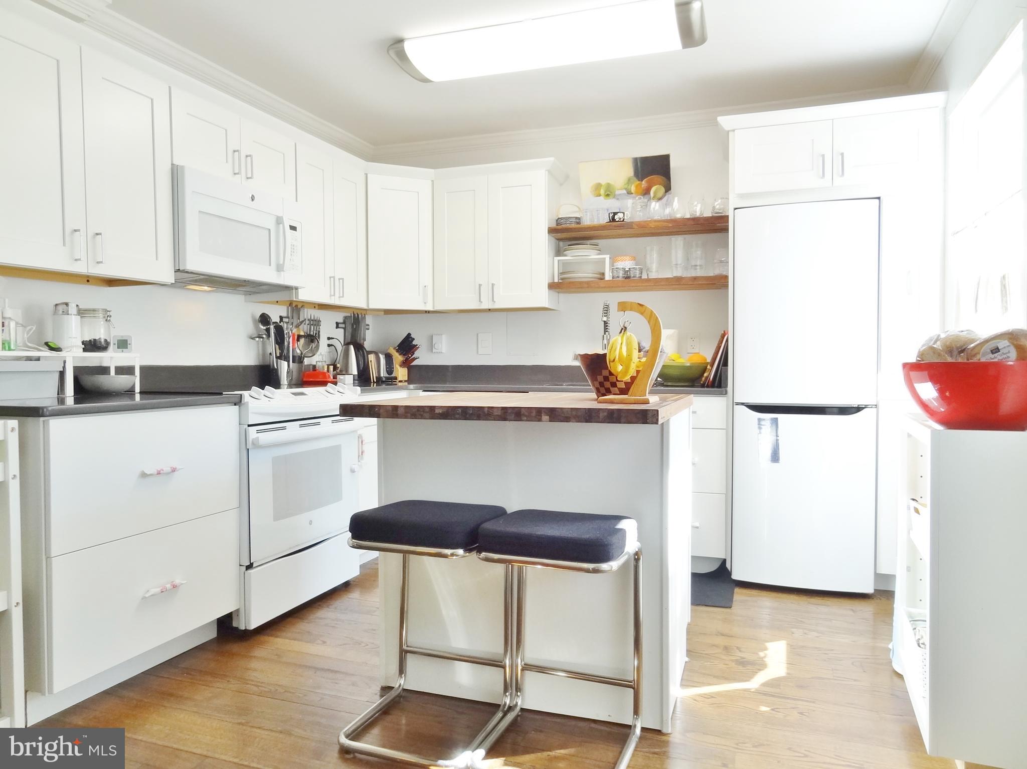 This amazing home has been completely transformed - this large, opened kitchen is a rarity in Greenbelt. Included are modern cabinets, appliances, countertops and breakfast bar. The light and airy dining area has an extra window for morning sunshine. There s a spacious laundry room (lots of storage) with full-sized washer and dryer under the stairs. The ceramic-tiled bathroom has upgraded fixtures, also. The fenced backyard with patio overlooks protected woodlands.. The recent GHI renovation program provided new doors, energy-efficient windows and baseboard heaters. Just a short jaunt to Roosevelt Center - groceries, theater, aquatic & community centers, restaurants, salons, bakery, banking & more. There s also many nearby playground spaces and a dog run, too! Total of $649.06 includes all TAXES, insurance, trash pickup, renovation program & most structural maintenance. (walls, roof, wiring, plumbing hot water heater & more.) Why rent when you can enjoy this home for less?
