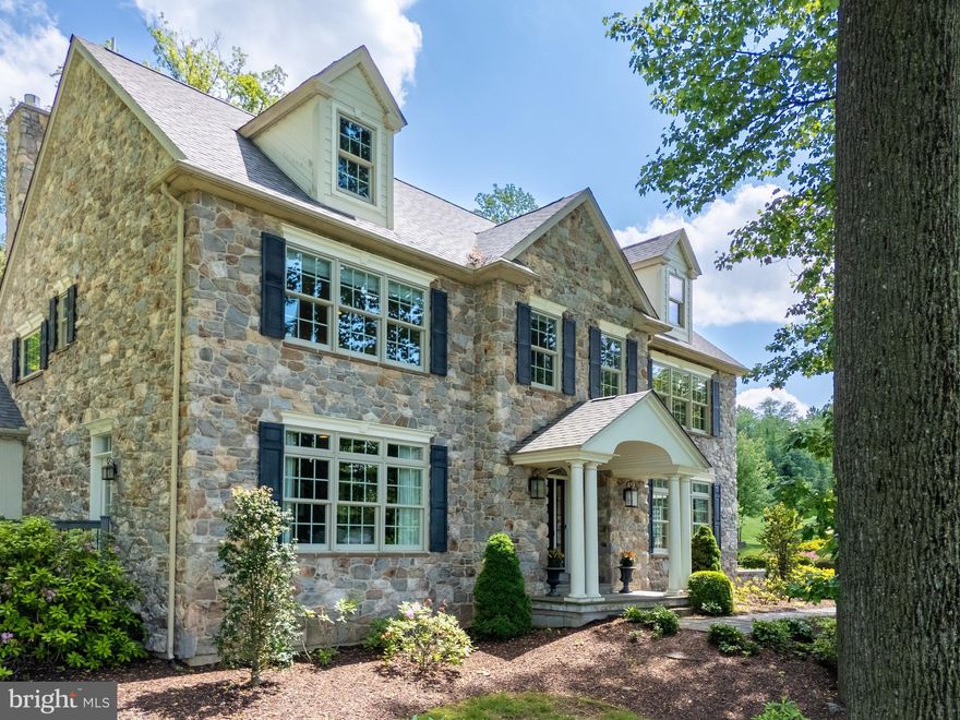 Perched high on a hill with SWEEPING MOUNTAIN VIEWS, this stunning, custom-built home offers refined living in a private, PICTURESQUE setting.  Featuring a FIRST FLOOR PRIMARY SUITE with a spa-like bathroom and a FIRST LEVEL GUEST ENSUITE with private porch access, this well-designed home also includes TWO SPACIOUS second level ENSUITE bedrooms AND an office/study. SOARING VAULTED CEILINGS and walls of glass flood the interior with natural light, enhancing the home’s open-concept design. The gourmet kitchen flows seamlessly into the light-filled GREAT ROOM with WET BAR, ideal for everyday living or sophisticated entertaining. The EXPANSIVE FINISHED LOWER LEVEL is perfect for gaming and family movie nights, and a dedicated FITNESS ROOM with a private sauna brings wellness home. Outside, the professionally landscaped grounds are a true sanctuary—surrounded by mature trees for shade and privacy. The BACKYARD VERANDA with BEAUTIFUL slate flooring and a wood-burning fireplace creates a cozy outdoor living area, perfect for year-round enjoyment. THE STUNNING PATIO PAVERS and walking paths lead through lush greenery and garden beds, inviting you to explore the beautifully manicured backyard and side yard. Additional covered porches, an oversized 3-CAR GARAGE, and PHENOMENAL VIEWS is where luxury meets tranquility, inside and out.