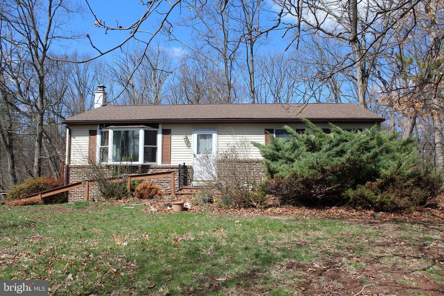 Don’t miss this great opportunity for investors or homeowners looking to add value and make this home shine! Nestled on over 1.25 wooded acres, this property offers stunning nature views and a small creek running through the rear yard. Enjoy the peaceful surroundings from the expansive deck, perfect for relaxing or entertaining.
Inside, the spacious family room features a cozy wood-burning stove, while the kitchen and dining area include a peninsula bar for casual seating. The home offers two well-sized bedrooms with ample closet space and a hall bath complete with a large vanity, soaking tub, and stall shower.
The unfinished lower level provides endless potential—finish it for additional living space or use it as a workshop or storage area. An attached one-car garage includes an extra side for equipment, a workshop, or storage for all your outdoor gear. Conveniently located near everything, this home is a rare find in the sought after Spring-Ford School District.