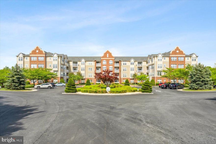 Rarely available, almost 2000 square foot condo in Worman's Mill, is one of the largest two bedroom models in the building. This unit is immaculate and over 400 square feet larger than most of the other two bedrooms in this secure building. Worman's Mill attracts buyers looking for luxury, convenience, amenities and quality of life.  This condo has an incredible feel from the moment you walk off the elevator and into your unit. There is a plethora of windows, creating ample natural light, hardwood floors, beautiful archways, and welcoming open space. Enter to an inviting living space with gas fireplace, ease of access to balcony and great ceiling height. The balcony overlooks a large myrtle tree that blossoms every late spring/early summer. To one wing, the living room leads to the dining room and kitchen. To the other wing, is the primary suite with en-suite bath and a large sitting area. The sitting area is perfect for a home office. There is a second bedroom with en-suite bath and ample closet space. The dining room is formal yet welcoming. The kitchen has an island, great countertop space, and a breakfast area. The breakfast area is a perfect place for a morning coffee or evening cocktail. Adjacent to the kitchen is massive pantry and laundry room. One of the great features of the condo is that just a couple steps out the back of building, you will have easy/fast access to a paved nature trail that weaves/connects within community (offering views of creek, birds, deer, etc.). You are also in walking distance to a lovely beach cove on the Monocacy River. The condo offers a large and spacious lobby area with ample parking for guests/visitors. The building features a lovely gathering spot with garden for condo residents only. This unit features TWO deeded and covered parking spaces in the garage. It also includes two extra storage units. Enjoy all Worman's Mill has to offer including community pool, walking trails and fine local restaurants--Plaza Mexico and Ricci. Ease of access to Wegman's, downtown Frederick and local shopping. Welcome home!