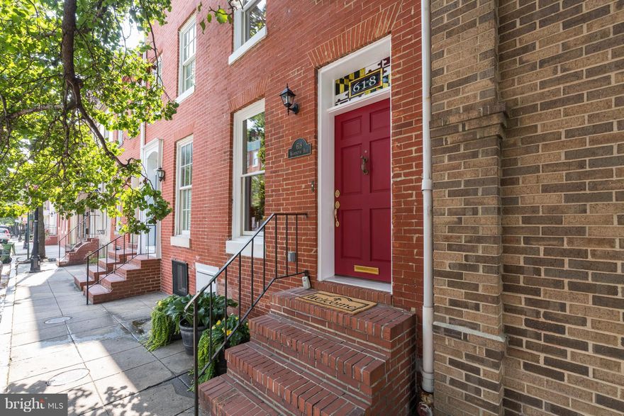 Updated 1840s row home walking distance to U of MD, Camden Line & the Inner Harbor. Modern updates compliment restored original features. LR w/ exposed brick, crown moulding, reclaimed mantle.  Kitchen w/ 48" maple cabinets, SS appliances, travertine floor.   Master BR w original random width pine floors. Master bath w beadboard & reclaimed wood vanity. Private rear deck w/ parking beneath.