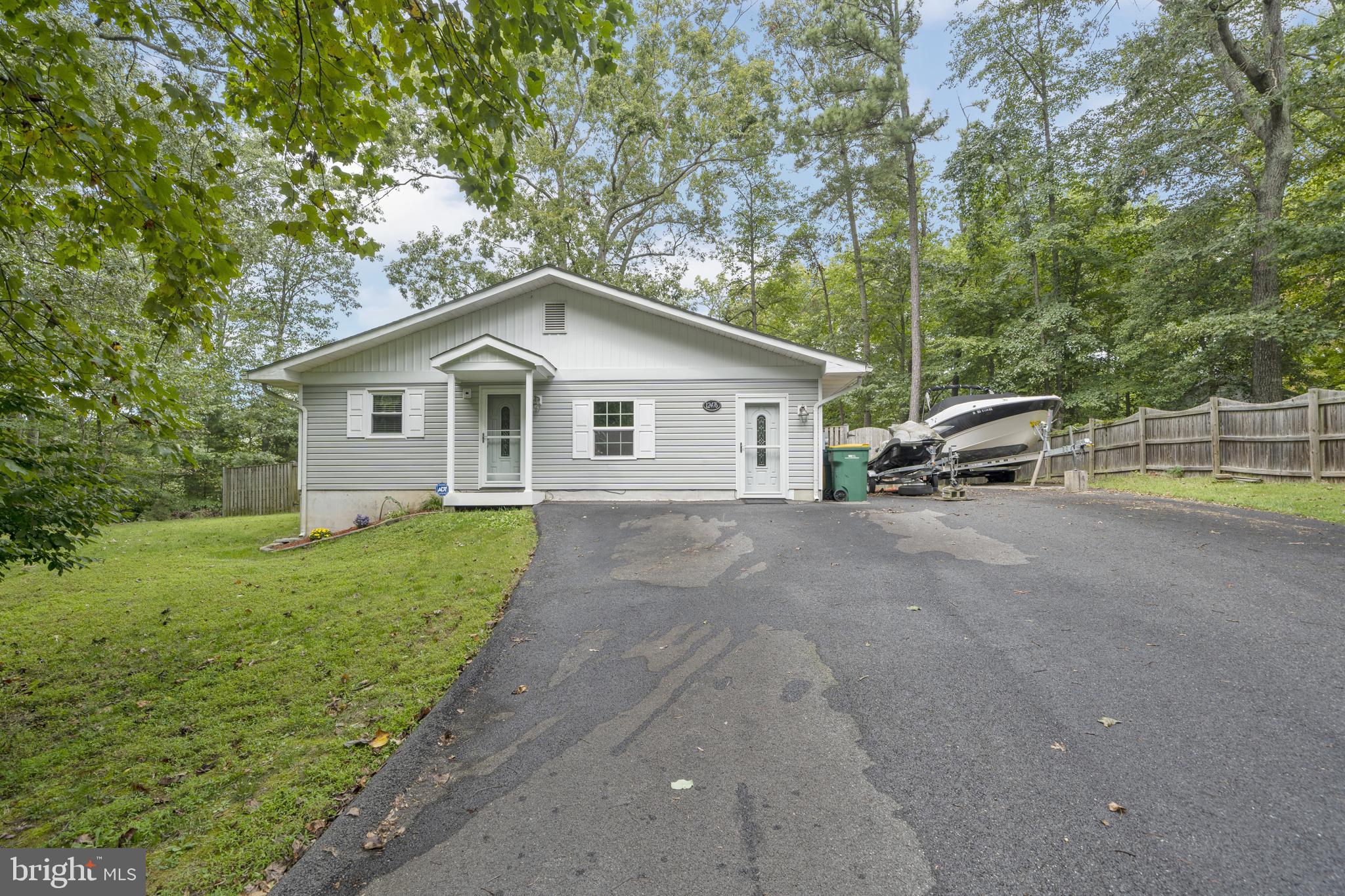 This charming single level home nested on a beautiful private site , Three bedroom and one full bath home has a open floor plan. Media Room with upgraded Vinyl Plank Hardwood. Kitchen has Stainless Steel Appliances and upgraded counter tops, Vinyl Plank Hardwood. Spacious Family Room opens to wrap around deck which is perfect for entertaining. The Community has endless amenities, beach, clubhouse, Playgrounds, lake & kayaking, perfect for family outdoor living.... Schedule your showing today before this one is gone!!! Please practice social distancing while showing face mask are required, PLEASE only two persons plus agent on Showings. This is a very unique property that.