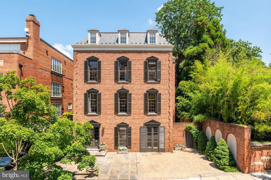 Distinguished and fully detached Georgian home prominently sited just steps from Kalorama's beloved Mitchell Park amongst ambassadorial residences and many of the District's most historically and architecturally significant properties. An airy and expansive floor plan of over 6,600 SF offers both wonderful social flow and ample privacy - featuring grand-scale, sun-filled rooms, distinctive architectural details, and classical European ambiance throughout. On the main level, formal living and dining rooms, a library, and a gorgeous (new!) Jennifer Gilmer kitchen - all with 10' ceilings - flow seamlessly together and outdoors to the deep and private romantic walled garden. Large primary suite with dressing room and renovated bath, plus four additional generous bedroom suites. Elegant reception hall with dramatic curved stairway and ELEVATOR to all floors! Attached one-car garage plus additional three-car driveway parking.