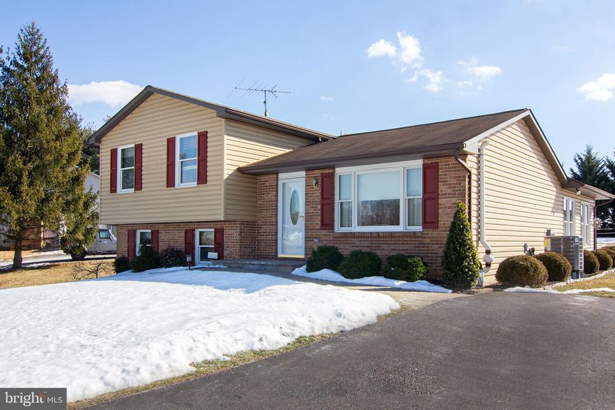 This meticulously maintained and updated home truly offers something for everyone, boasting 4 finished levels and an unfinished basement with endless potential. As you enter through the updated leaded glass door, you'll step into the foyer and immediately feel at home in the inviting living room, featuring a large picture window that floods the space with natural light and beautiful wood flooring that flows seamlessly into the dining area, up the stairs, and down the hallway. The kitchen is an entertainer's delight, with ample granite countertops, plenty of prep space, and included appliances, making it both functional and stylish. Adjacent to the kitchen is the sun-soaked Great Room, where soaring cathedral ceilings, a ceiling fan, skylights, and a cozy wood accent wall create a warm, airy atmosphere. Two atrium doors lead out to a wraparound concrete patio, which overlooks the expansive and usable rear yard—perfect for relaxing or entertaining. Upstairs, the upper level offers three spacious bedrooms, each with ample closet space. The hall bath and primary en-suite bath have both been updated with new vanities, and the primary bath also features a modern shower enclosure. The primary bedroom boasts new carpeting, while both bathrooms feature ceramic tile flooring for a sleek finish. The lower-level family room is another highlight, featuring large front and rear windows, a sliding glass door to the side patio, multiple closets (one with a potential half-bath rough-in), and a pellet stove framed by charming corner brick walls. There is also the full sub-basement which provides abundant storage space and houses the laundry area (washer and dryer included), as well as the nearly-new heat pump and central air system (less than 1 year old), radon system, and sump pump. Some of the many recent updates include; 10 replacement windows  in '22, Heat Pump/Central Air & humidifier & water heater are less than 1 yr old. All of this is situated on an elevated 1.03-acre lot that offers scenic views and breathtaking sunsets. The property also includes two sheds, one of which is equipped with electricity and a garage door—perfect for a workshop or additional storage. Don’t miss this rare gem that combines comfort, functionality, and charm in a picturesque setting. Schedule your showing today!