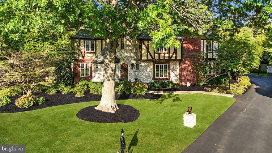 Nestled on the very end of the Moon Circle cul-de-sac, this custom-built 5500+ SF home calls to you with it's storybook curb appeal and with attention to detail that is evident the moment you approach. The solid wood custom door opens into a classic 2-story foyer with imported Italian marble tile, curved staircase and large walk-in closet. Follow into the expansive of the living room, which has 10 foot ceilings and is fitted with hardwood floors, window seat, and gas fireplace with marble surround. Continue through to the hexagonal sunroom, where walls of windows let in light and beautifully finished hardwoods, crown mouldings, and bookshelves flanking the north side of the room make a statement. To the left of the foyer is a hexagonal half bath that balances the sunroom design and features double sinks, crystal chandelier and two windows. The dining room is a statement room as well. Display your favorite pieces on the floor to ceiling custom custom built shelves, complete with recessed lighting and prepare for dinner parties with the large butlers pantry closet as it was originally designed for a formal meal to be serviced from the hallway. Beyond this, find the more impressive kitchen, complete with cherry-stained maple cabinets, two pantries with pull out drawers, and storage below the cozy bay window seat. The stained glass cabinets, carved lion head door fronts, expansive quartz topped island, and the vaulted angled ceiling set the tone for this magnificent space. A spacious Subzero refrigerator with twin doors and double freezer drawers (both with ice makers) has been paneled to blend in and is paired with a 5 burner gas Thermador range, double wall ovens, and GE warming drawer. Not only is this kitchen a delight to prep and cook, clean up is made easy with its full size dishwasher and the Fisher and Paykel panel-front single washer. Hosting a party has never been easier when you have a kitchen beverage center with paneled double drawer refrigerator and coffee station and room for kitchen dining while overlooking the family room. This generous room accesses a convenient full bath, the laundry room, and the rear yard's terraced patio. From here descend to a larger patio complete with sitting wall, octagon planters, and a secluded hot tub that takes in views of the lush 1+ acre grounds. Right beyond the blooming shrubs, tucked away on the southern part of this property is the concrete Sylvan Pool, complete with Pool shed. Back inside through the stained glass side door is he mudroom with its skylight and vaulted ceiling, makes this space feels more luxurious than it does utilitarian but it has many storage closets, and provides access to the full bath and laundry facilities. Upstairs, find 5 large bedrooms and 3 full baths, including a primary suite with renovated high-end bath complete with radiant tiled flooring and complementary dressing room. The main bedroom itself has a large sitting room, and the bedroom itself has a California style brick gas fireplace, wood mantle, and accesses a private balcony above the sunroom. The 2nd bedroom has its own full bath and double closet. The remaining three bedrooms share a newly renovated full hall bath and are generously sized and have double "California closets" and large windows. To complete the 2nd floor, all new hardwood flooring has been installed throughout this level.  A heavily insulated attic space has all the potential for finishing as a third floor. Outside the bedrooms is a closet that could be converted to secondary laundry room as hookups are already in place. Finally, the lower-level finished basement space completes this luxury home. A mahogany wet bar with York custom cabinetry, sink, dishwasher and mini-fridge is finished with brass foot rail, while matching mahogany wainscoting throughout the basement, including a separate TV area, presents a feel of a European Pub. Come see this one of a kind home located in the heart of Bucks County, PA!