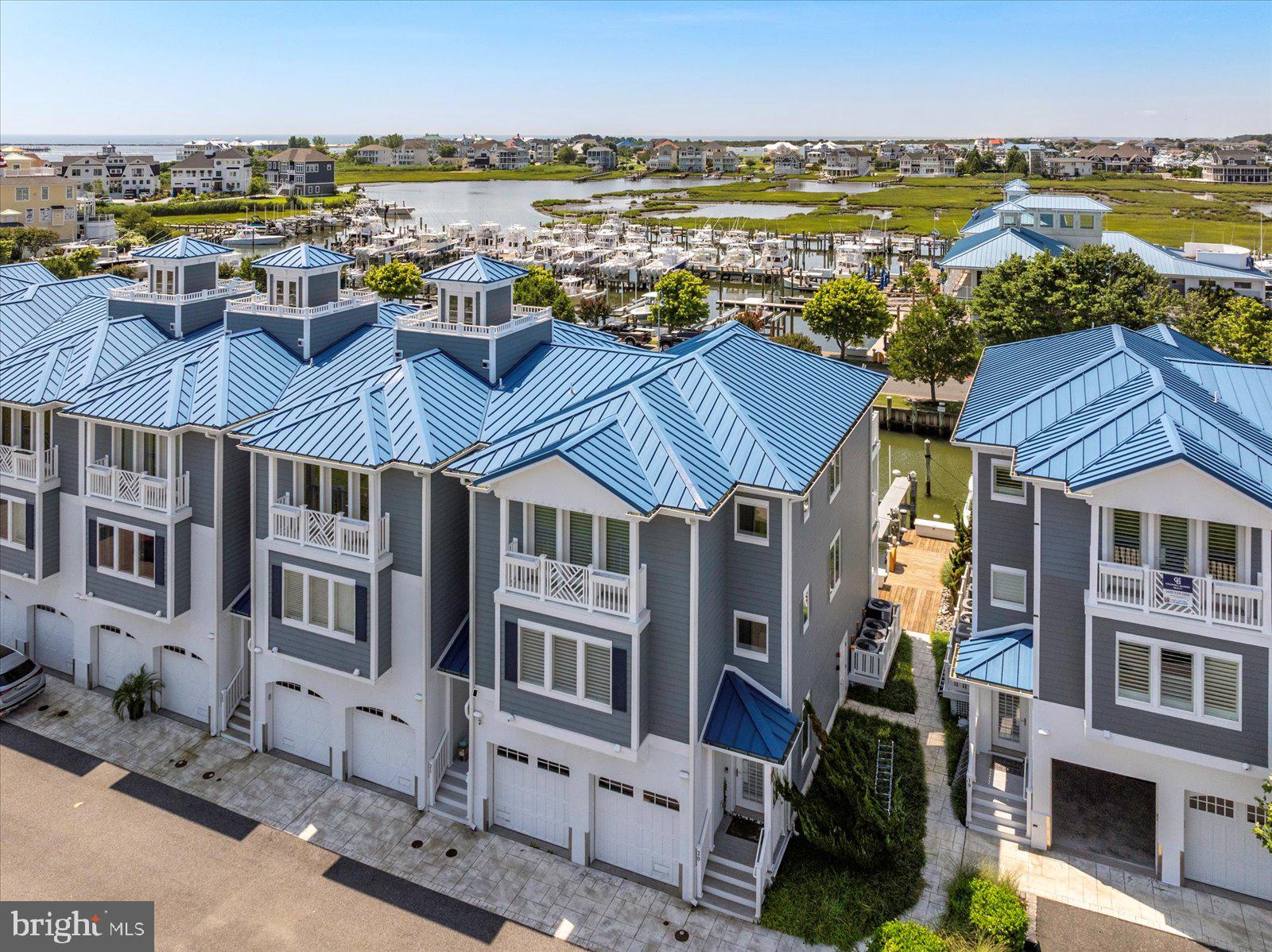 A stunning small townhome community is right off Route 50 with incredible water views on BOTH sides and direct water access right out your back door! This is not just a home – it’s a lifestyle. Step inside and be wowed by the gourmet main kitchen, spacious open-concept living area, with designer finishes throughout, including elegant custom crown molding and custom tile work in every bathroom. The layout is ideal for entertaining, with a second kitchenette and walk-out access to your large deep water dock just steps away – perfect for hopping on the water in minutes. Wake up to the sunrise from your primary suite's private waterfront deck, and enjoy the sights and sounds of coastal Maryland right from bed. Each bedroom is tastefully designed with comfort and style in mind, and natural light fills every corner of this home. Enjoy the community pool and convenient access to the OC bridge, a private dock, multiple balconies, and water views from nearly every window, this property truly offers the best of Eastern Shore coastal living.