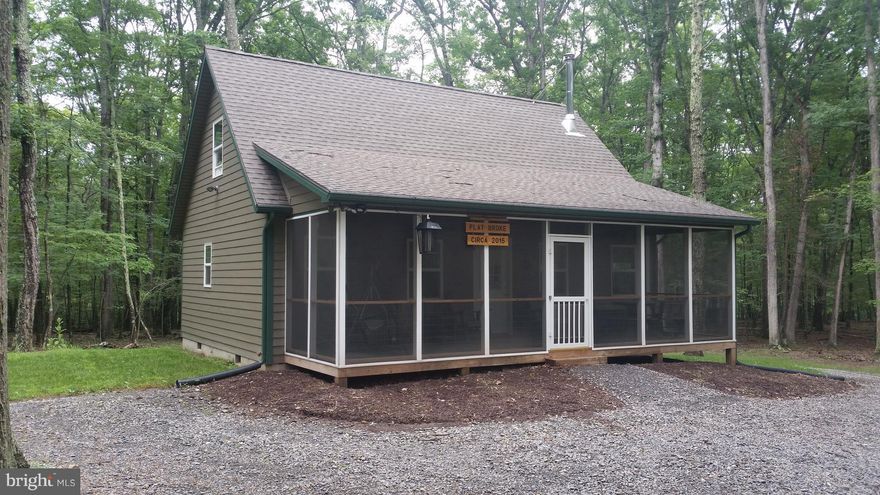 AS-NE,100% Maintenance Free Chalet with Cacapon River Access, Built in 2015, used very lightly, you'll be impressed with the condition and layout of this weekend get away. Great Room design with wood stove, 1 bedroom and loft, 1.5 baths and will comfortably sleep 6. Nicely Furnished, Beautifully wooded private lot just up the mountain from the community river lot. Ready to enjoy NOW, call Today!