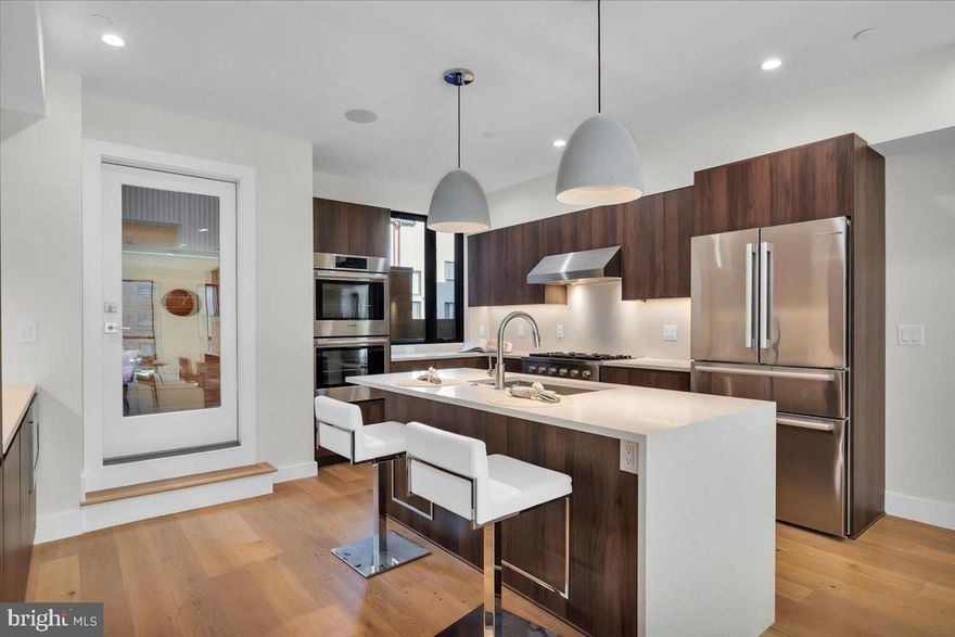 The Duo on Arch is a progressively designed pair of CORNER homes built in one of the Philadelphia's premier neighborhoods - Logan Square - featuring TWO car parking and is located on a front facing corner with beautiful southern exposure! These stunning homes will capture you from the moment you walk up. The handsome charcoal exterior will be contrasted by a stunning pivoted natural wood door. Upon entry, you will walk into a nicely designed foyer space along with the 4th bedroom and full bathroom which could be a perfect office setup. The second floor is a wide open layout with a massive kitchen featuring custom Porcelanosa cabinetry, Bosch appliances, and quartz counters as well as backsplash. The kitchen also leads you to your private deck allowing outdoor entertainment right off the main living area! Pass through the dining room into the expansive living room that is sun-soaked. The sleek and modern corner fireplace captures your focal point while leaving plenty of space for furniture arrangement. The third floor conveniently holds the primary suite with a huge bedroom, massive closet, and a stunning designer bathroom with a wet room, freestanding tub, and double vanity. The fourth floor features two graciously sized bedrooms and beautiful bathrooms, plus laundry and a wet bar. Last but not least, the stunning roof deck with perfect skyline views! HOME CAN BE SOLD FULLY FURNISHED. These homes include the FULL tax abatement applied for. It is the responsibility of the buyer to verify square footage and taxes.