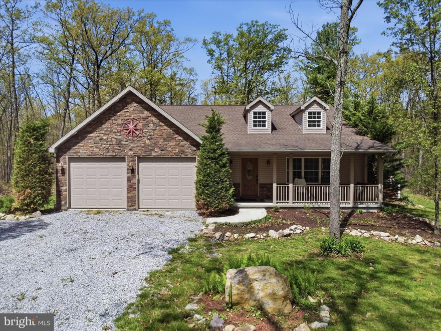 Set on 7.3 sprawling wooded acres back a private lane from Means Hollow Road, this exquisite 5-bedroom, 3-bathroom manor offers a harmonious blend of contemporary elegance and rustic charm. Built in 2013, this custom built home showcases a thoughtful architectural design that seamlessly integrates modern living with the tranquility of nature. Step inside to discover 20 foot cathedral ceilings, true hardwood floors, custom woodwork, allowing a seamlessly blended warm and inviting interior, where natural light dances through spacious rooms adorned with high-end finishes. The heart of the home features a well-appointed kitchen equipped with premium appliances, including a built-in microwave and dishwasher, ensuring culinary adventures are both enjoyable and efficient. The central vacuum system adds a touch of convenience, making maintenance a breeze. Outside, the property is a true sanctuary. The exterior is beautifully crafted with a combination of brick veneer, stone, and vinyl siding, exuding timeless appeal. A charming partial wraparound deck invites you to unwind and soak in the peaceful surroundings, perfect for morning coffee or evening gatherings. The outbuilding, complemented by a wood/metal shed, provides ample storage for outdoor equipment or hobbies. The expansive lot is at the end of a private cul-de-sac setting, surrounded by lush trees and wooded areas, creating a secluded atmosphere that feels worlds away from the hustle and bustle. Enjoy the freedom of outdoor activities, with hunting, hiking, mountain biking, kayaking. fishing opportunities right at your doorstep, making this property a nature lover's dream. Parking is a breeze with a circular gravel driveway leading to an attached garage with front entry, accommodating multiple vehicles with ease. This residence is not just a home; it's a lifestyle. Experience the perfect blend of luxury, comfort, and nature in this exceptional property, where every detail has been meticulously crafted to create a warm and inviting atmosphere. Embrace the tranquility and exclusivity that this remarkable home offers, and make it your own.