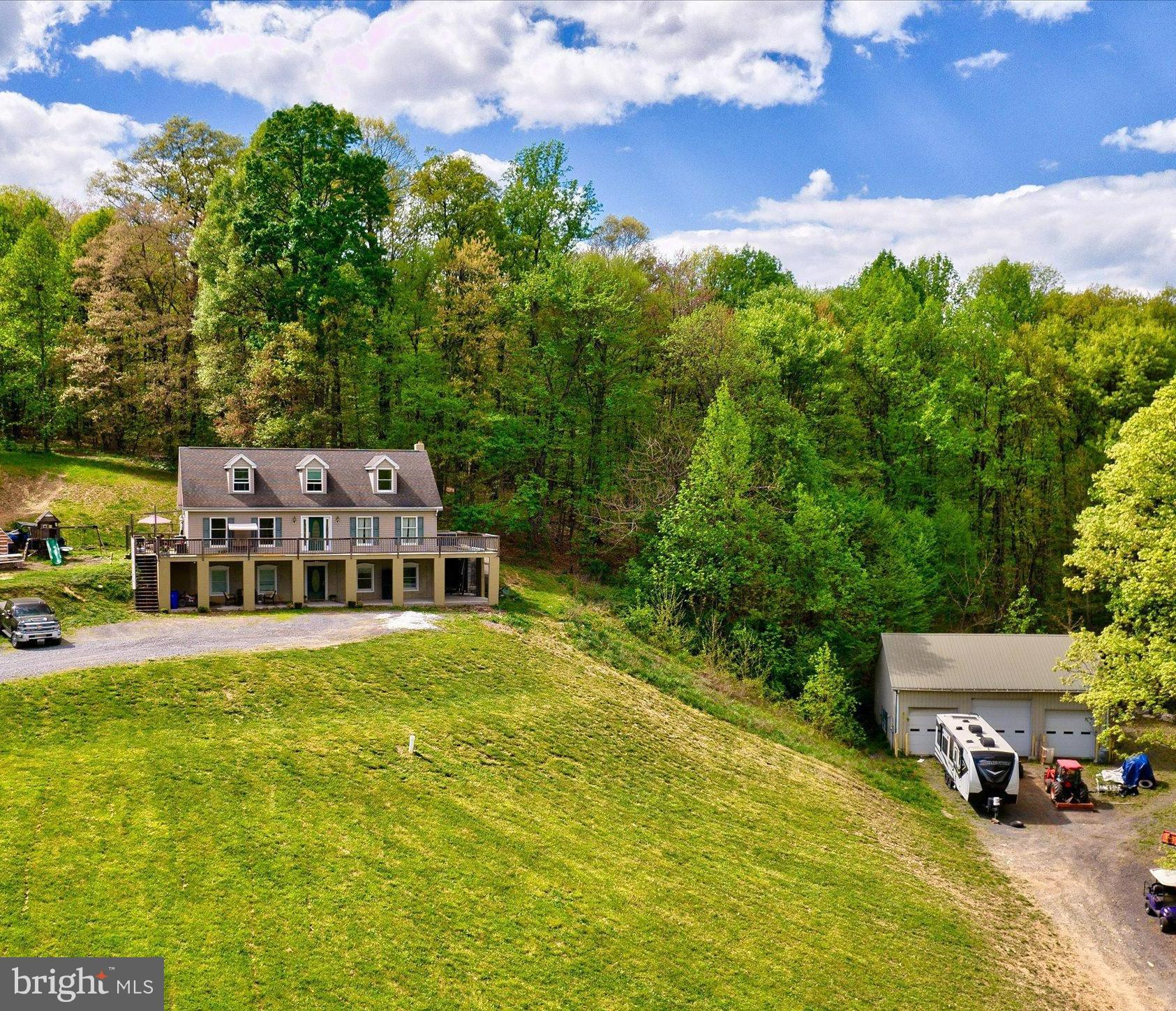 NO SHOWINGS 6/22 - 6/27 Peaceful living on 5 acres in Frederick! Feels like the country, yet minutes to everything! Relax on your wrap around deck and enjoy the view! Main level of home has primary bedroom and primary bathroom with jetted soaking tub; upper level has 2 bedrooms and full bath. Lower level has in-law suite or tenant-ready apartment with two bedrooms (or use one as a living room) equipped with own kitchen and full-sized washer/dryer. Hardwood flooring throughout much of the home. Kitchen has updated stainless ZLINE and Bosch appliances including a 6 burner gas ZLINE range for the gourmet cook! Walk-out level basement has in-law suite or revenue-generating 1 bedroom room apartment with huge recreation area and wood stove that stays with the property. Property has a detached 3 bay garage/shop with Lift that will be sold with the property. The garage has 2 10x10 bay doors and 1 12x12, air compressor hookup, commercial-grade insulation, cable/phone lines, electric, water inside and outside on the hosebib. Two sheds are also on the property that convey - Property has a 36' deep well line to basement footers, foundation is 9" thick poured concrete, Well pump 7 years old and 550' deep. Wooded area on side of property adds to the serene, peaceful feel along with a small stream. Feels like you are in a country-setting but minutes to Frederick and Leesburg. Frederick has so much to offer - restaurants, Baker Park, home to Fort Ft. Detrick, plenty of shopping and a fabulous Downtown district. 24 HOUR NOTICE TO SHOW PLEASE!
