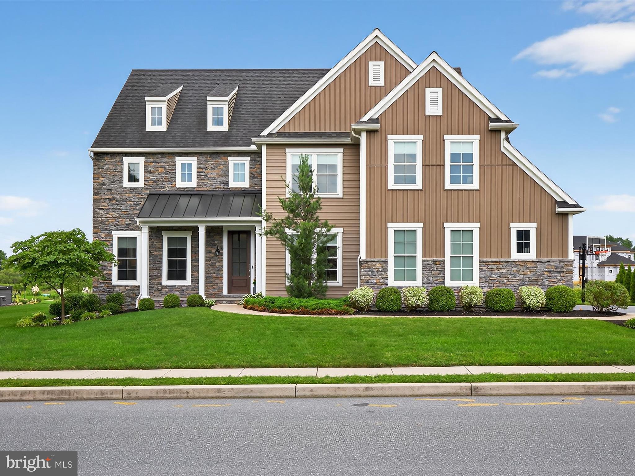 Welcome to 548 E Delp Road! A Stunning EG Stoltzfus Built Home in the Highly Desirable Brooklawn Community! This beautifully maintained 4-bedroom, 3.5-bathroom home offers over 3,600 square feet of finished living space on a half-acre lot in the heart of Manheim Township. Built in 2018, this like-new home blends timeless quality with modern luxury. From the moment you arrive, you'll be impressed by its eye-catching curb appeal, enhanced by mature landscaping, a welcoming front entry, and elegant architectural details. Step inside to a grand two-story foyer and be greeted by 9-foot ceilings throughout the main floor, creating a bright, open atmosphere. The home is filled with beautiful natural light, and the open-concept layout offers seamless flow between living spaces. The custom chef's kitchen is a true highlight, featuring quartz countertops, a large center island, high-end appliances, a built-in double oven, vented range hood, and upgraded white cabinetry, ideal for both entertaining and everyday living. Set off to one side of the home, the family room boasts soaring vaulted ceilings and a stunning stone-wrapped gas fireplace, offering a warm, inviting retreat. Additional main floor features include a private study, first-floor laundry, and tasteful finishes throughout. Upstairs, the private Master Suite offers a relaxing retreat with a spa-inspired bathroom and a spacious walk-in closet. Three additional generously sized bedrooms and well-appointed bathrooms complete the upper level. Enjoy outdoor living on the EP Henry paver patio, which overlooks a private view of nature from the backyard, providing a peaceful and serene setting. A 3-car garage and full basement with 9-foot ceilings offer exceptional finish potential for additional living space, storage, or recreation. The home is equipped with energy-efficient natural gas heating and a gas water heater, providing year-round comfort and cost savings. Located in the Manheim Township School District, and just minutes from top-rated schools, shopping, dining, and commuter routes, this exceptional property delivers the perfect combination of luxury, efficiency, and location. Call to schedule your showing today!