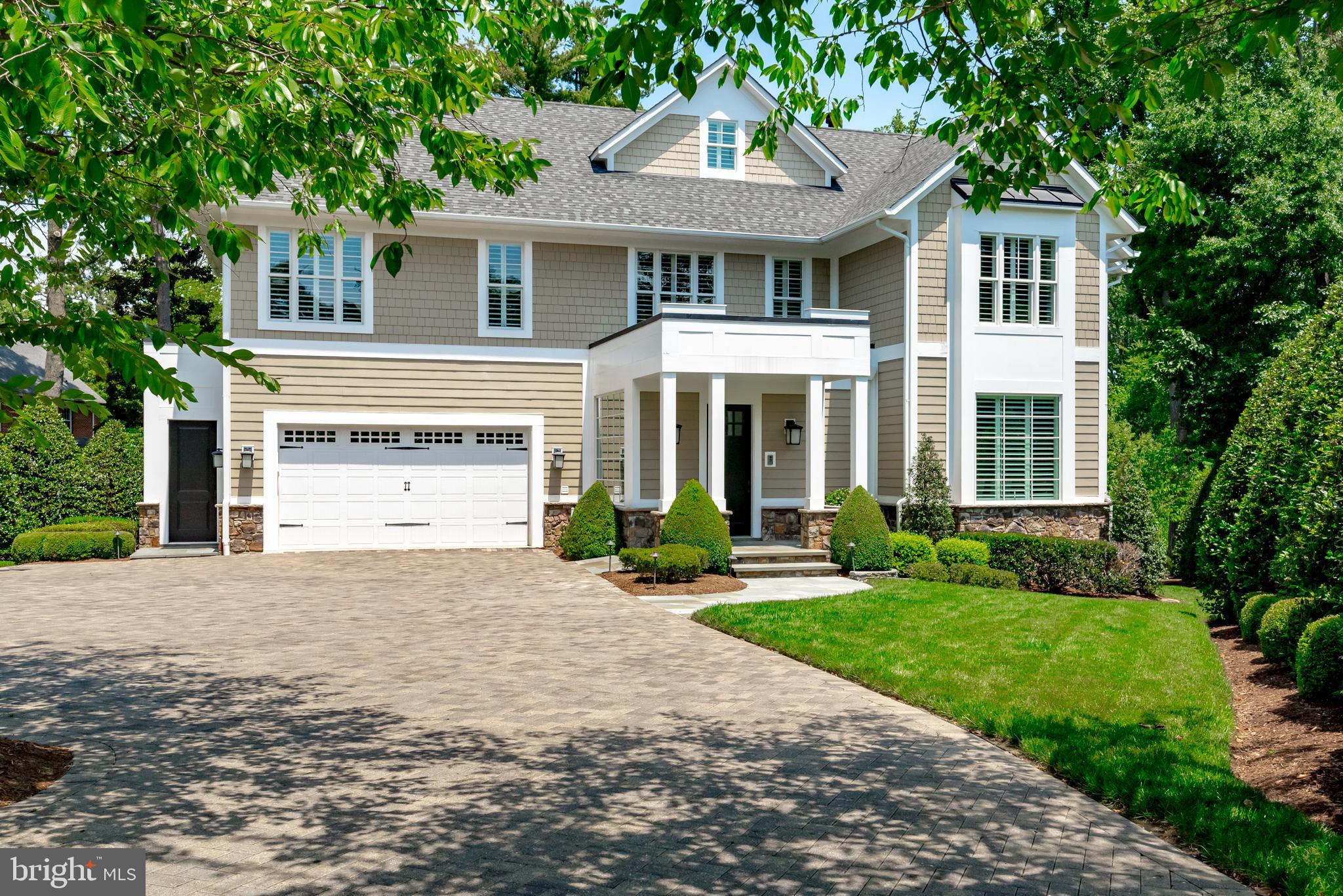 Experience luxury living in this elegant and meticulously maintained Wardour residence. This custom landscaped property is situated on a .43-acre lot and offers over 7,500 sq. ft. of elegant living space across four levels. As you step inside, you are greeted by an open floor plan featuring soaring 10-foot ceilings complemented by 8-inch base moldings and 8-foot doors. The great room boasts of a coffered ceiling, a gas fireplace, and built-in bookcases, creating a warm and inviting atmosphere. Recessed lighting and beautiful hardwood floors are found throughout the home. The renovated white kitchen is a chef’s dream, equipped with top-of-the-line appliances, including a Sub-Zero freezer and refrigerator, a Wolf 6-burner stove, and gleaming marble countertops. Entertain with ease on the spacious Ipe deck located off the kitchen, perfect for hosting gatherings. The home features six generously sized bedrooms and six and a half luxurious bathrooms all with built in closets. The primary suite is spacious and includes two spacious walk in closets and a sitting room/office space. The dual staircase and elevator shaft offer convenience and accessibility throughout the home. Full house generator.
The walk-out lower level opens to a stunning hardscape oasis including a flagstone patio with an outdoor wood-burning fireplace, overlooking a flat yard perfect for outdoor activities or lacrosse practice. Enjoy easy access to the community path leading to the nearby Wardour beach, where you can launch your kayak and explore the waters of the Severn River. Located in the highly sought-after West Annapolis School District and walking distance to all the fabulous west Annapolis hip new restaurants and shops. Don't miss this one!