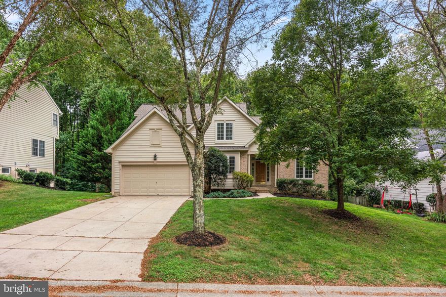 Must see! Located on a ⅓-acre lot in the desirable River Hill community, this well-kept home backs to forest conservation park land, offering privacy and wooded views from the rear deck. New roof (2022), replaced Carrier gas HVAC (2012), and gas water heater (2012). Inside, the main level features tall 9' ceilings, gleaming hardwood floors, a spacious eat-in kitchen with 42" white cabinets, stainless steel appliances, and a bay-window breakfast nook. The adjacent family room includes a gas fireplace, built-in bookcases, and vaulted ceilings. A hard to find first floor primary suite features tall vaulted ceilings, dual closets (one walk-in), and a large en suite bath with soaking tub, separate shower, and dual sinks. French doors lead to a bright office or living room with soaring cathedral ceilings. A separate dining room with crown molding and chair rail adds additional formal space. The main level also includes a mudroom with front-loading washer/dryer and a recently updated powder room with modern finishes. Upstairs are three additional bedrooms with brand-new carpeting (2025) and an updated hall full bathroom with dual sinks, modern tile, and brushed nickel fixtures. The full walk-out basement offers double doors to the rear yard, utility sink, and potential for endless future finishing customization. Enjoy access to Columbia’s 90 mile extensive pathway system, tot lots, community pools, and more. Zoned for sought after River Hill HS!