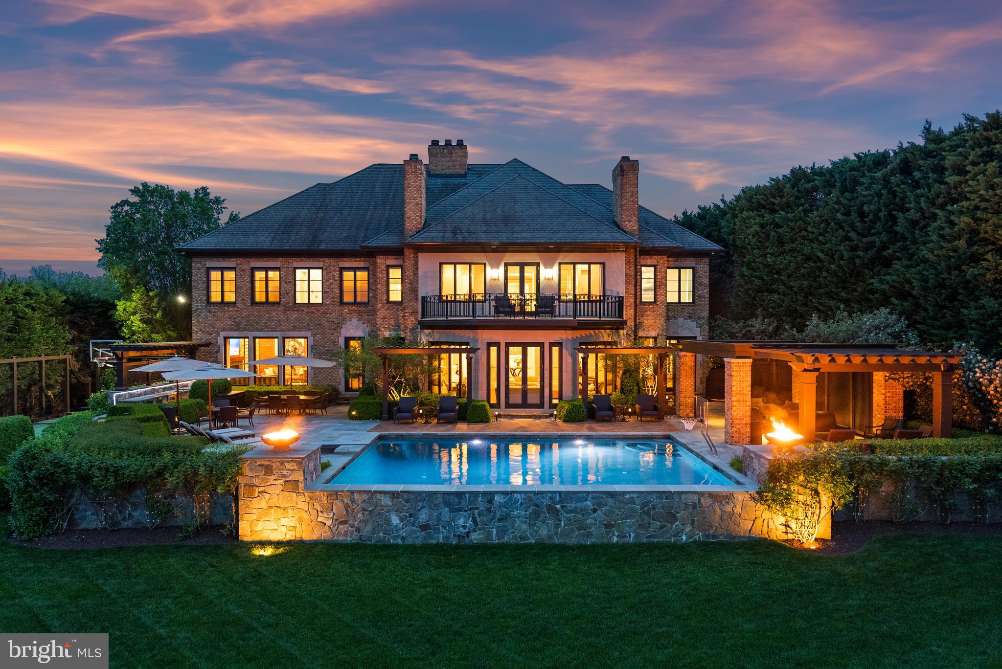 Welcome to your luxury waterfront sanctuary on the Severn River, located in the highly coveted Downs on the Severn community of Annapolis. This extraordinary estate offers unmatched amenities including a private sport court, heated saltwater pool, and private pier with a tram to easily transport you and your guests to the water’s edge for unforgettable days on the Bay. Inside, the craftsmanship is unparalleled and the curated finishes reflect that no expensive was spared to create a home of distinction. The main level flows from the stately foyer, the soaring rotunda that serves as a formal dining room and meticulously constructed office to the beautifully appointed Living room, wet bar, Gourmet Kitchen and Family room all with stunning views of the river below. The attention to detail throughout is designed to impress while creating a warm and inviting home for day to day waterfront living. The bonus dog room with shower, laundry, and refrigerator with access to the dog run is perfect for animal lovers! A fully finished lower level invites relaxation and entertainment with a game room, steam room, home gym, and guest quarters. The bar area and possible wine tasting room/wine cellar adjacent to the elevator are ready for your personal touches to make it your own. Upstairs, the stunning primary suite is a true retreat with private balcony overlooking the pool and waterfront, dual bathrooms, custom vanities, 2 expansive closets, a private massage room, and a second-level laundry suite with an in-home salon for discreet hair and makeup sessions. An oversized, glass-enclosed luxury shower connects the two spa baths, offering breathtaking views of the river below. The 3 additional ensuite bedrooms provides ample room and privacy for guests and family. Outside, the heated saltwater pool with deep end diving board boasts unobstructed water views and expansive pool deck area including fully equipped outdoor kitchen, a pavilion to enjoy the shade, stunning fire bowls and easy access to the water below. The deep water private pier features multiple slips and 40,000lb boat lift; creating an effortless and fun atmosphere while cruising down the Severn River to the Chesapeake Bay and beyond. Experience a life of privacy, resort-style amenities, and timeless beauty in this one-of-a-kind waterfront masterpiece. Welcome Home!