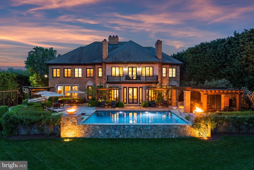 Welcome to your luxury waterfront sanctuary on the Severn River, located in the highly coveted Downs on the Severn community of Annapolis. This extraordinary estate offers unmatched amenities including a private sport court, heated saltwater pool, and private pier with a tram to easily transport you and your guests to the water’s edge for unforgettable days on the Bay. Inside, the craftsmanship is unparalleled and the curated finishes reflect that no expensive was spared to create a home of distinction. The main level flows from the stately foyer, the soaring rotunda that serves as a formal dining room and meticulously constructed office to the beautifully appointed Living room, wet bar, Gourmet Kitchen and Family room all with stunning views of the river below. The attention to detail throughout is designed to impress while creating a warm and inviting home for day to day waterfront living. The bonus dog room with shower, laundry, and refrigerator with access to the dog run is perfect for animal lovers! A fully finished lower level invites relaxation and entertainment with a game room, steam room, home gym, and guest quarters.  The bar area and possible wine tasting room/wine cellar adjacent to the elevator are ready for your personal touches to make it your own. Upstairs, the stunning primary suite is a true retreat with private balcony overlooking the pool and waterfront, dual bathrooms, custom vanities, 2 expansive closets, a private massage room, and a second-level laundry suite with an in-home salon for discreet hair and makeup sessions. An oversized, glass-enclosed luxury shower connects the two spa baths, offering breathtaking views of the river below. The 3 additional ensuite bedrooms provides ample room and privacy for guests and family. Outside, the heated saltwater pool with deep end diving board boasts unobstructed water views and expansive pool deck area including fully equipped outdoor kitchen, a pavilion to enjoy the shade, stunning fire bowls and easy access to the water below.  The deep water private pier features multiple slips and 40,000lb boat lift; creating an effortless and fun atmosphere while cruising down the Severn River to the Chesapeake Bay and beyond.  Experience a life of privacy, resort-style amenities, and timeless beauty in this one-of-a-kind waterfront masterpiece. Welcome Home!