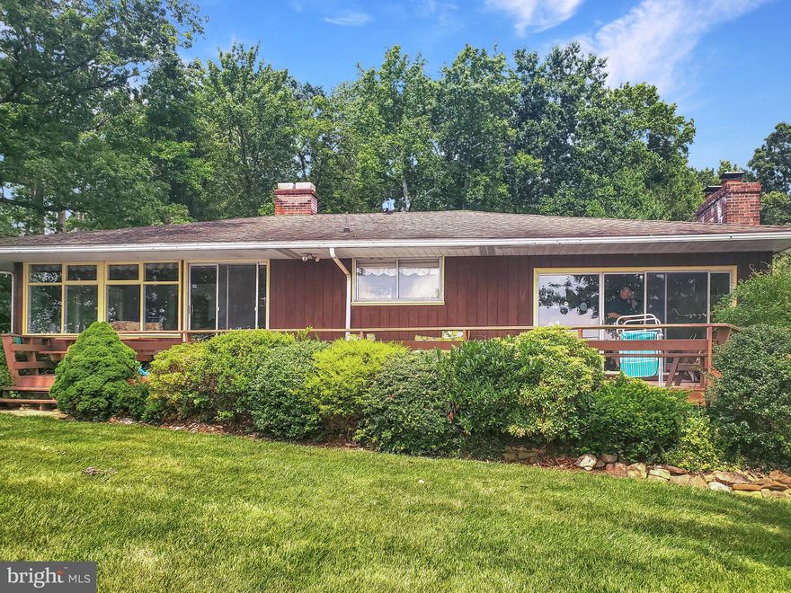 Wonderful beach front setting on the Elk River.  This 3 bedroom 2 bath ranch features 100 feet of water front with concrete bulkhead, boat ramp and beach.  Enjoy the huge water facing deck, screened in porch and two fireplaces.