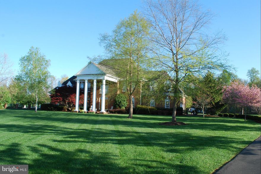 Breathtaking custom-built private estate with tons of unique touches. Soaring 2-level foyer w/ marble floors leads to double spiral staircase up.French doors from multiple rooms to wonderful outdoor spaces. Spacious kitchen w/granite, new DW/oven, ceramic tile floors. Hardwoods on main level. Library, mud room. Fam room w/ vaulted ceiling, wood-burning fireplace, bar. Must see to appreciate!