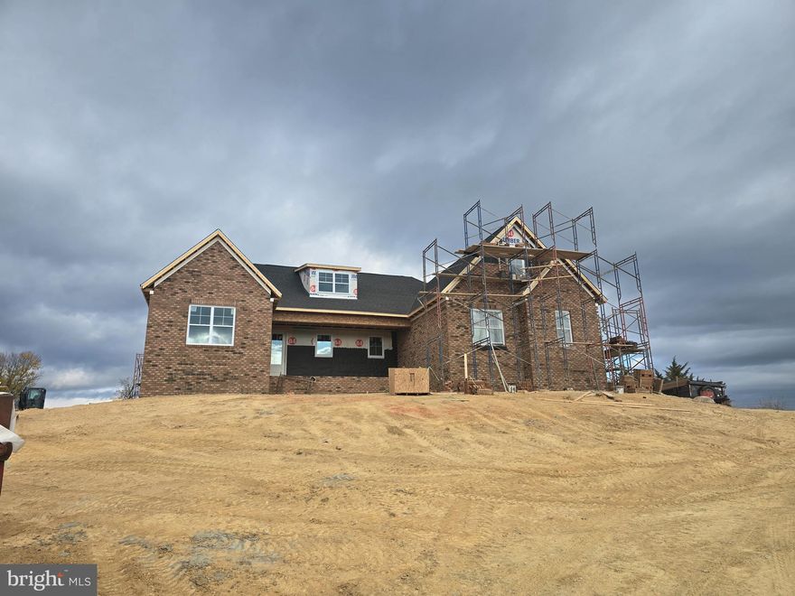 This home will be completely brick. The photos are of the identical home that was built in Leesburg Va.  Photo s of the home in brick will be posted as soon as the scaffolding is removed. This home sits on lot with magnificent views of Signal Knob to the south and the blue ridge to the west. Million dollar views.  NO HOA. Completion date will be March 2025.