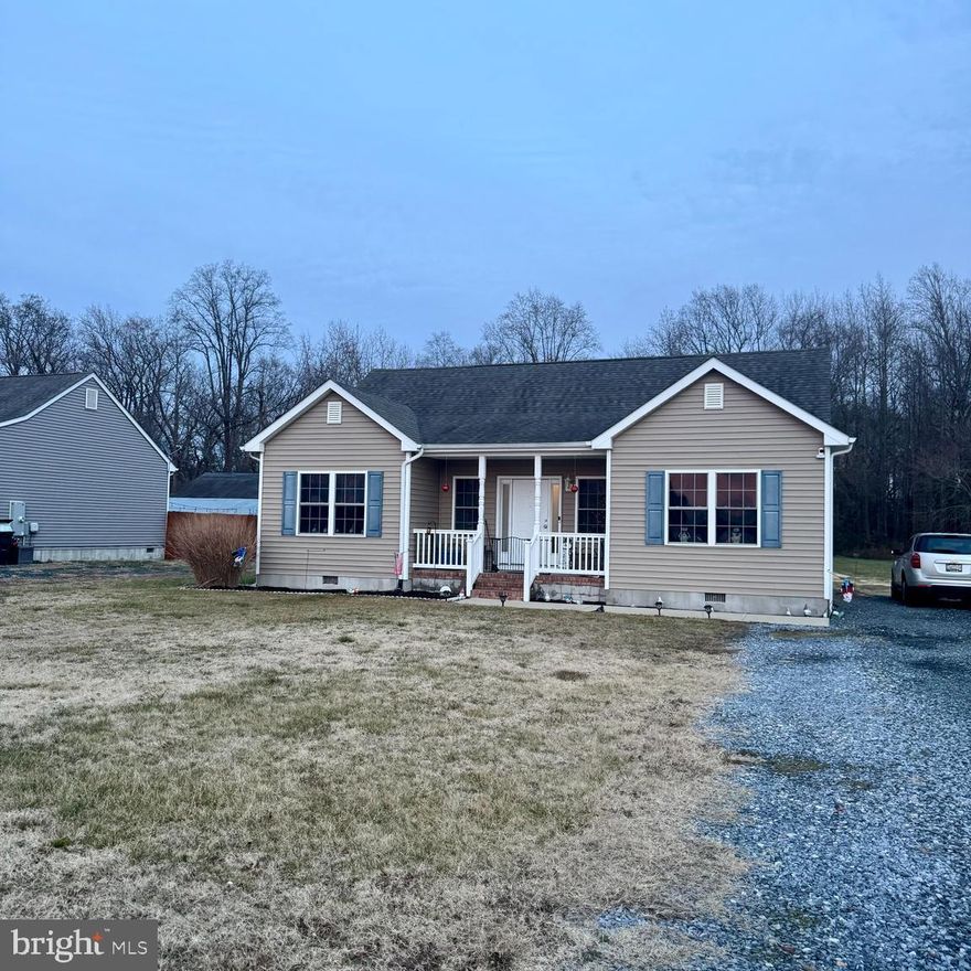 Welcome home to this charming three-bedroom, two-bath home set on a spacious lot, where comfort and easy living come together beautifully. A welcoming covered front porch invites you to slow down and settle in, whether you’re enjoying a quiet morning coffee or gathering with friends at the end of the day. Step inside to a modern open floor plan that seamlessly connects the main living spaces, creating a natural flow ideal for everyday living and relaxed entertaining. The kitchen is a true standout, featuring granite countertops, stainless steel appliances, rich, warm wood cabinetry, a pantry for added storage, and convenient main-level laundry. The kitchen remains open to the dining area and spacious living room, making it easy to stay connected. The primary suite is thoughtfully tucked away on its own side of the home, offering privacy along with an en suite bath, ceiling fan, and plush carpeting for a comfortable retreat. Two additional bedrooms are nicely sized and share a full hall bath, perfect for family, guests, or a flexible bonus space. Just off the kitchen, a rear deck overlooks the expansive backyard, providing plenty of room to play, garden, or host summer barbecues under the open sky.  Off-street parking in the driveway adds everyday convenience. Ideally located in Delmar, Maryland, this home offers easy access to commuter routes and is just minutes from Salisbury, allowing you to enjoy both small-town charm and nearby shopping, dining, and amenities.