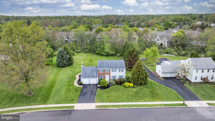 Welcome to 634 Conestoga Lane, a classic Betsy Ross colonial in Towamencin Township offering 2,266 square feet of well-planned living space on a .70-acre lot on a cul-de-sac street in Lansdale, PA.

A slate-floored foyer sets a polished tone and leads to a formal living room and a separate dining room enhanced by crown molding and chair rail. The custom kitchen features 42" cabinetry, granite counters, a double sink with gooseneck faucet, breakfast bar, recessed lighting, tile flooring, beautiful windows and double atrium doors that open directly to the backyard deck, creating a smooth indoor-outdoor flow.

Adjacent to the kitchen, the family room includes a brick wall with slate mantle fireplace and views of the rear grounds. A convenient powder room and access to the oversized two-car garage complete the main level.

Upstairs, you will find four well-proportioned bedrooms and two full bathrooms, including a hall bath and an en-suite bath in the main bedroom, providing flexibility for a variety of living arrangements.

Outdoors, the property offers a maintenance-free deck, a paver hardscape patio, and a large, flat backyard suitable for recreation, gardening, or entertaining. A large shed provides additional storage beyond the oversized garage.

Located in the North Penn School District and Towamencin Township with easy access to area roadways, shopping, and local services, this property combines a traditional colonial layout with practical updates and a generous homesite. This lovely property is  ready for its next owner.