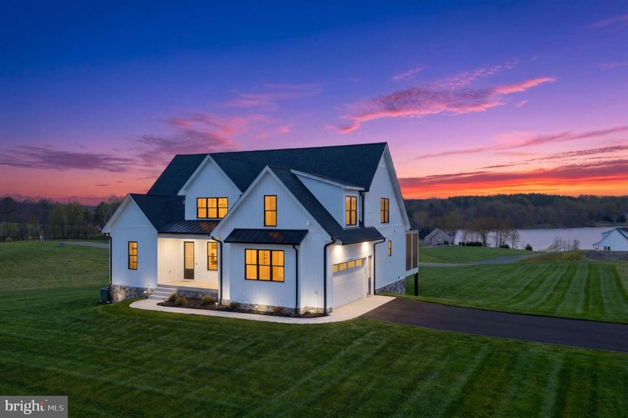 Stunning Lake Home with Breathtaking View!!!  Local builder Hawkins Custom Homes presents a luxury contemporary craftsman style lake home in the picturesque and serene Land’s End community on the public side of Lake Anna. Set on a premium corner lot of nearly two acres, this beautifully crafted masterpiece offers sweeping 180-degree water views with the added assurance that no future construction will obstruct your sightline, along with a deeded boat slip located just a few hundred feet along the shoreline of the common area. Whether you’re seeking a full-time residence, a relaxing weekend lake retreat, or a smart investment opportunity, this home delivers—with short-term rentals permitted.  Rental Projections available.

This sprawling five-bedroom, three-and-a-half-bath lake home offers over 4,200 square feet designed for both comfort and an elevated living experience, featuring open main-level living and a thoughtfully designed layout. As you step inside, you’re welcomed by a spacious office through French doors on the right and a flex room on the left, perfect for a variety of uses. The main living area showcases coffered ceilings, recessed and halo lighting, and top-of-the-line Marvin windows known for their superior energy efficiency and strength, all framing stunning lake views.

The kitchen is a true showpiece and a cook’s dream, featuring quartz countertops and a full quartz backsplash, stainless steel appliances, wine fridge, pantry, and both upper and lower cabinet lighting—blending function and style. Just off the kitchen, you’ll find a convenient additional room ideal for an owner’s closet, butler’s-style prep space, or extra appliances, along with a half bath nearby.

The main-level primary suite captures gorgeous water views and includes a spa-like ensuite with a freestanding soak tub, tiled shower with seating, dual vanity, and a spacious walk-in closet. For added convenience, the laundry is located just off the primary suite on the main level.

Upstairs, you’ll find three additional spacious bedrooms, a full bath, and a full-height attic space that can be finished for even more living area or storage. The walkout lower level continues the home’s beautiful lake views and offers incredible versatility, featuring a family room, recreation area, theater room, utility room, fifth bedroom, and a third full bath.

Outdoor living is just as impressive, with a screened-in porch and an open back deck perfect for grilling and entertaining while taking in the lake setting. Below, the concrete patio is covered by a waterproof deck—ideal for corn hole, entertaining, or even adding hammock swings for relaxing lakeside.

The home is fully wrapped in board and batten vinyl siding, creating a cohesive and striking exterior. Entire exterior maintenance free...vinyl/synthetic/pvc....no exposed wood.  The fully finished side-entry garage is thoughtfully equipped with space for workbenches and well-placed electrical outlets, a 16x8 insulated door, smart garage door opener connected to your phone, EV charger, and hot and cold water access. The expansive lot also allows room for a future detached garage—ideal for additional vehicles or lake toys.

Additional features include dual-zone HVAC, a paved driveway, and FiberLync cable for high-speed connectivity. Conveniently located just over an hour from Northern Virginia, with easy access to local favorites like Tim’s at Lake Anna, Below Deck, mini golf, The Cove, and more, this home offers the perfect blend of lake living and refined design in a truly picturesque setting. Pictures do not do this home justice—this property has a wow factor you must see for yourself!  Some photo's are virtually staged.