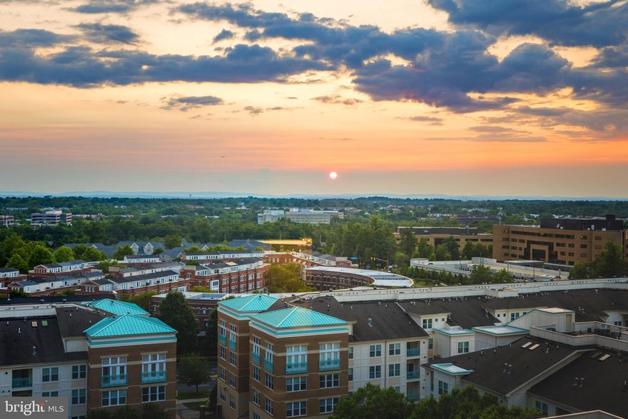 3 assigned parking spaces and views from every room is the standard in this luxurious high rise home located in walkable Reston Town Center. An open floor plan with dual primary bedrooms and 2 full baths this turnkey home boasts 2 dedicated parking spaces right next to the elevator, dedicated climate controlled storage, 9 foot ceilings, 4" Brazilian Cherry floors, designer light fixtures, two panel raised doors, Lutron light switches, and wood blinds on all windows. The floor to ceiling windows in the sky room provide unobstructed views as far as the eye can see to the West. Kitchen is well appointed with rich cabinetry, stainless steel appliances, gas stove,, and granite countertops to include an island peninsula. The 1st primary bath includes large soaking tub, frameless shower enclosure, and on trend vanity with granite top. The 2nd primary bath has a shower enclosure with a shower seat, a designer vanity with granite top, and porcelain tiles. Each closet has custom built ins.  Each floor of Midtown only has 8 units per floor. A stones throw to the new metro, 267, and Fairfax County Pkwy. Midtown amenities include pool, fitness center, meeting rooms, movie theater, 24/7 concierge, and more. W&DO trail is one block away. Enjoy maintenance free living in one of the trendiest town centers in all of Northern Virginia.