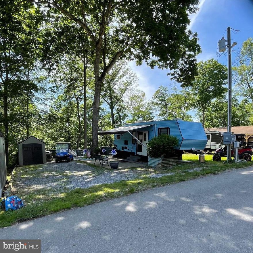 To view the property and Riverbend park since this is a gated community so you need to enter at the guard shack. Entry is not permitted without ID per the office rules. Bring ID's to the office or guard shack for visitor pass.
 THIS IS A SEASONAL CAMPGROUND -OPEN FROM APRIL 1 TO NOVEMBER 1.   River Bend is a privately owned 400 acre recreational- vehicle camp resort with seasonal activities for members, families and guests. This great RV park is tucked away on the Upper Potomac River of West Virginia, River Bend is one of West Virginia's most popular family seasonal destinations. . Just a short drive from the Washington and Baltimore metro area. Open with utilities from April 1 to November 1. (Lot owners have access to their property during the off season).   Riverbend Park offers lots of fun and entertainment, or a great place to get away and relax.  
10 miles of Deep water on the Potomac River, access for boating, fishing & swimming and other park amenities  include 3 swimming pools, putt putt course, Horseshoe club, Boat club, Poker runs, Trick or Treat, Christmas in July, live bands, basketball court, tennis court, fireworks, car show, Church, restaurant, bar, convenience store, playground, volleyball, ball field and much much more. 
This lot is ready to enjoy now all set up with 1995 clean camper,  bedroom with King size bed, couch that pull out to bed, and dining table can be set up for sleeping area.  TV's convey and 2 shed, and also the gas golf cart which is a 4 seater.  The roof on camper was recently sealed, newer 30 gallon hot water heater, there is 2nd refrigerator to convey, crank out awning and lot backs to trees.  Ready for some fun and/or relaxation?  Come check it out!