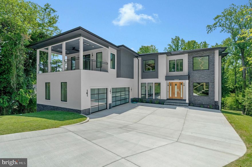 PRICE IMPROVED! Modern Elegance Meets Resort-Style Living in the Heart of McLean
Nestled on a rare, flat 31,533 sq ft lot in a quiet McLean enclave, this architecturally striking residence blends modern design with resort-style amenities. The expansive, level grounds are ideal for a future pool or a game of soccer, easily watched from the comfort of the screened porch—perfect for family living and entertaining.
Backing to a tranquil creek and lush wooded views, the property offers exceptional privacy and a serene natural setting. A sleek stucco façade, expansive glass windows and doors, and a spacious three-car garage create impressive curb appeal.
Inside, soaring 10-foot ceilings on all levels enhance the home’s open, airy atmosphere. Luxurious finishes include 10-inch wide pre finished oak hardwood floors, solid 8-foot modern doors, and exotic designer lighting throughout. The open-concept layout flows seamlessly into a dramatic family room featuring a floor-to-ceiling linear gas fireplace, and a large screened porch with metal-framed screens and a gas fireplace—ideal for year-round entertaining.
The primary suite is a private sanctuary, complete with its own gas fireplace, a Juliet balcony, and a secluded terrace overlooking the scenic backyard. Whether you're sipping morning tea or enjoying a quiet evening read, the peaceful natural surroundings are always in view. The ensuite bathroom is a modern masterpiece, featuring heated floors, elegant finishes, and spa-like comfort.
Each additional bedroom on the upper level is ensuite, offering exceptional privacy and comfort for family or guests. Every room includes custom walk-in closets, marble-topped vanities, and beautifully tiled bathrooms that reflect timeless elegance and quality craftsmanship.
The fully finished, walk-out lower level continues the home’s luxurious feel with high ceilings, large windows, and abundant natural light. At the center is an expansive recreation room with a custom wet bar, rich wood paneling, ambient lighting, and a cozy stone fireplace. A state-of-the-art media room with tiered seating provides a true cinematic experience, while a dedicated exercise room with access to a full bath offers flexibility for workouts or guest accommodations.
Located just minutes from downtown McLean, top-rated schools, premier shopping, dining, and major commuter routes, this residence offers a rare combination of luxury, livability, and convenience.