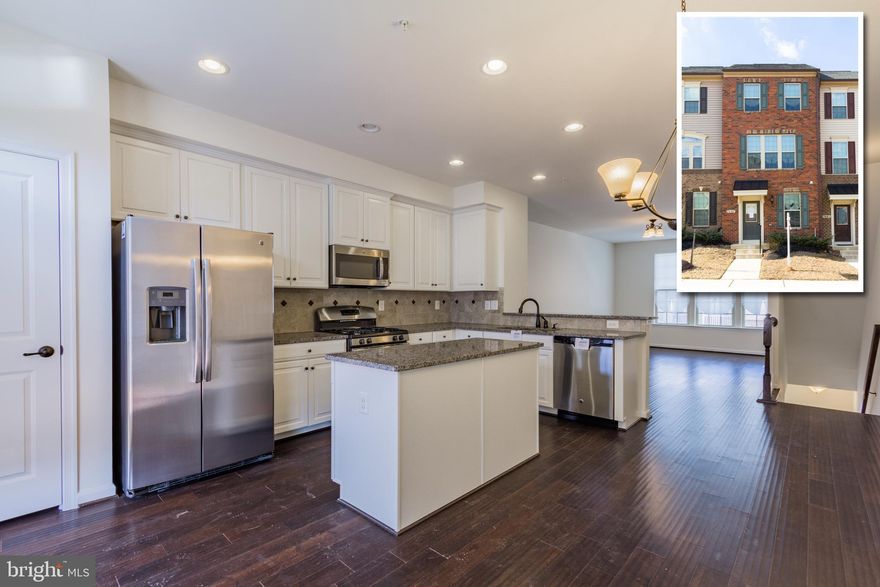 WHY WAIT FOR NEW CONSTRUCTION WHEN YOU CAN MOVE RIGHT INTO THIS GARAGE TOWNHOME WITH UPDATED FINISHES! Hardwood floors throughout, entry level den w/ half bath, open main level w/ spacious living room, dining area, & island kitchen w/ granite counters & ss appliances, Master suite w/ crown molding, 2 closets & full bath w/ dbl sinks & Roman shower, 2nd bedroom w/ hall bath, rear deck, 1 car garage, & driveway parking!  Sold As-Is!