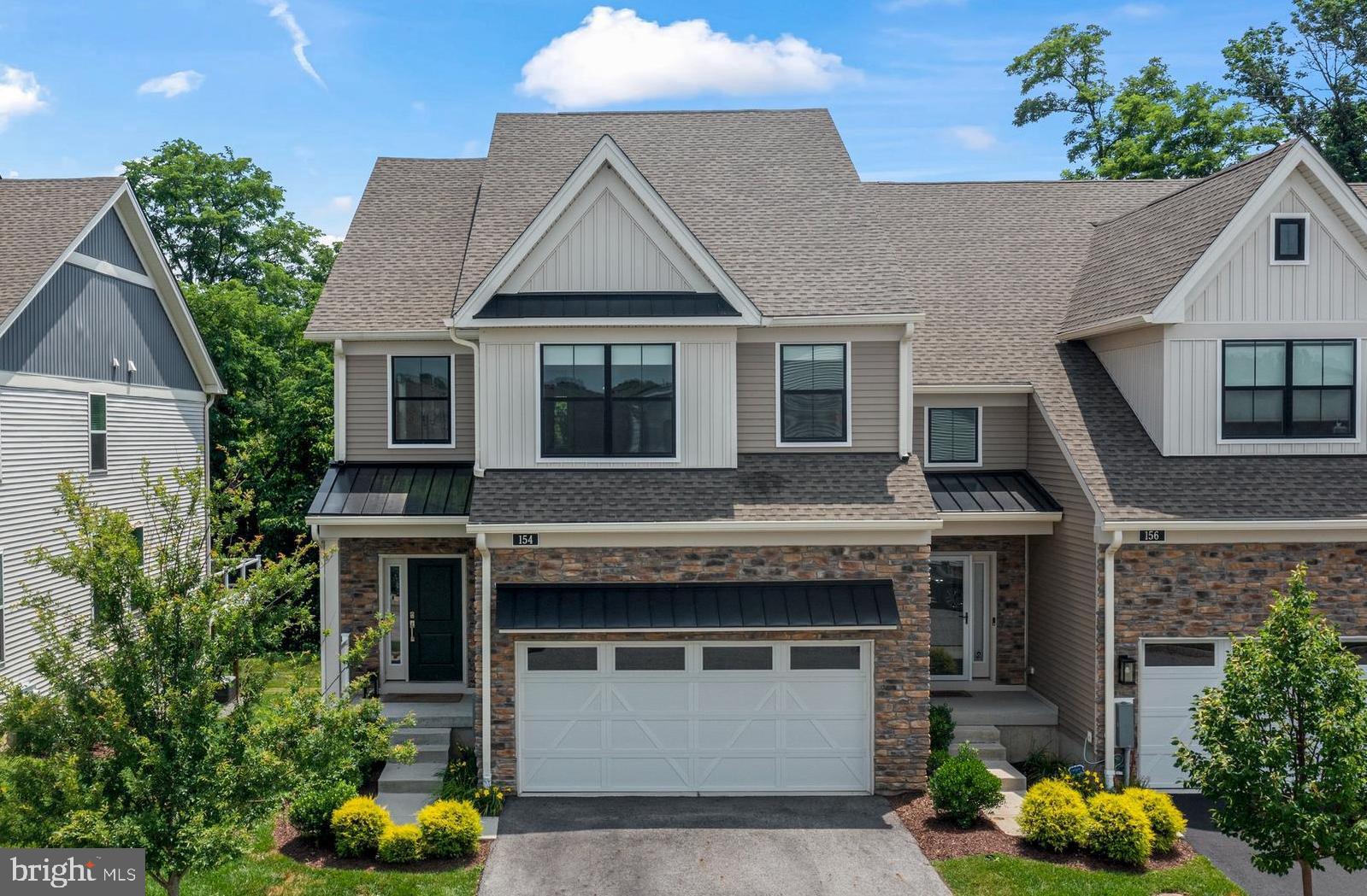 Welcome to 154 Kennedy Drive, a beautifully appointed end-unit carriage home nestled in the sought-after Franklin Station community in Media. From the gourmet kitchen to the private, wooded views in back, this exceptional 3-year-old home offers a luxurious, low maintenance turnkey lifestyle.
Designed with both style and comfort in mind, the home features soaring 9-foot ceilings, upgraded hardwood flooring, and expansive windows that bathe the space in natural light thanks to its desirable southern exposure. The open-concept main level flows effortlessly, beginning with a chef’s Kitchen that anchors the home. Highlights include upgraded cabinetry with quartzite counters, upgraded appliances including a chimney-style exhaust hood, recessed lighting, and a large island with a stainless steel farmhouse sink and ample breakfast bar seating —perfect for both casual dining and entertaining.
Off the Great Room, a sun-drenched Study provides a peaceful retreat for working from home and features glass French doors for privacy. Enjoy outdoor cooking on the natural gas grill on the large rear deck – with privacy panels on each side and sweeping, uninterrupted views of the surrounding woods. A Powder Room and access to a two-car Garage complete the main level.
Upstairs, a 2nd floor Loft offers flexible living space, ideal for exercise, reading, or homework/office area. The Primary Suite includes an upgraded Bathroom with a private water closet, expanded shower, double vanity with quartzite counters, tiled floors, and a large walk-in closet. Two additional well-sized bedrooms share a well-appointed Hall Bathroom with a tub/shower combo. A convenient Laundry Room is also located on this level.
The finished daylight Lower Level provides even more living space, complete with durable luxury vinyl plank flooring, another half Bath, and sliding glass doors to the rear yard. This level was upgraded with a wet bar with a wine/beverage frig and icemaker – ideal for entertaining! Tech fans will appreciate this home’s enhanced WiFi, CAT-5, and audio upgrades.
Franklin Station offers resort-style amenities including a community pool, clubhouse, and fitness center—making every day feel like a getaway.
Located in award-winning Rose Tree Media School District, this home is just steps from the Wawa SEPTA train station, offering quick access to Center City Philadelphia. Enjoy abundant restaurant and shopping choices (including Trader Joes) in the nearby town of Media and easy commutes to the Airport or Wilmington. Outdoor lovers will appreciate exploring nearby trails in Swarthmore and in Ridley Creek State Park.
Don’t miss your chance to own this luxurious, low-maintenance home in a peaceful and private setting. Schedule your tour today!