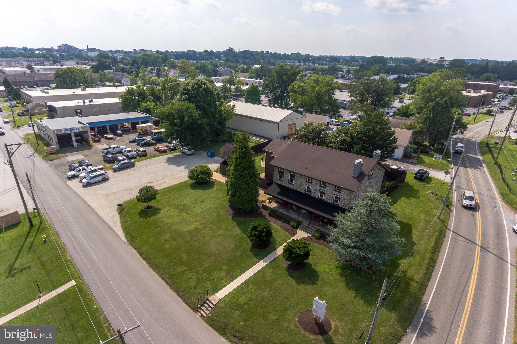 Business Owner or Investor Alert!!! Unbelievable One of Kind very unique property! Huge 8 Bay Garage (a 5,560 sq. ft building) with overhead doors currently being used by an auto mechanic, two of the bays are high enough for large trucks. In addition to the 8 bays there is a separate attached one car garage. Surprise!...the two huge paved parking lots can fit roughly 40+ vehicles! Great for parking in West Chester! Own a piece of history with this Gorgeous Stone Front Colonial, (4,876 sq ft.) starting with the fantastic curb appeal leading up to the wonderful extended front porch. Previously used for office space, but currently being used for housing rentals. The Current home (pictured) is being used by the owner, but can easily be rented or turned back into office. As you enter into the solid wood front door, off of the front porch, it will lead you into the living room w/ amazing interior stone walls w/deep set windows, and the original stone fireplace, a real plus! Wow!!! Deep set windows and the amazing original stone walls are seen throughout this amazing house. The stunning chef s delight eat-in kitchen is sure to please the most discriminating of chefs, accented with stone walls, wood ceiling and tile floor, equipped with built in stainless steel appliances, featuring the stainless steel range hood, all wood cabinets, high stunning vaulted ceilings. Includes a pantry cabinet, corian countertop and so much more! Continuing on the main floor is the formal dining room, great to entertain for holiday dinners and family gathering. Relax at the end of the day in the First Floor Master Bedroom suite with cedar ceilings, barnwood and a sliding barn door leading to the private bath. On the second level is a generously sized bedroom with full bath and huge walk-in closet with organizers, continue up a few steps to an additional spacious bedroom and loads of storage. Outside the fenced in backyard gives plenty of privacy to enjoy a BBQ or dine outdoors on the paver patio surrounded by flowering bushes, trees and shrubs. The list goes on with another feature... One bedroom upstairs apartment with stunning fireplace and nice floor plan with its own separate entrance. Both garage and one bedroom are currently being rented on a month to month lease. This property has so much to offer and too much to mention. Schedule your tour today!!