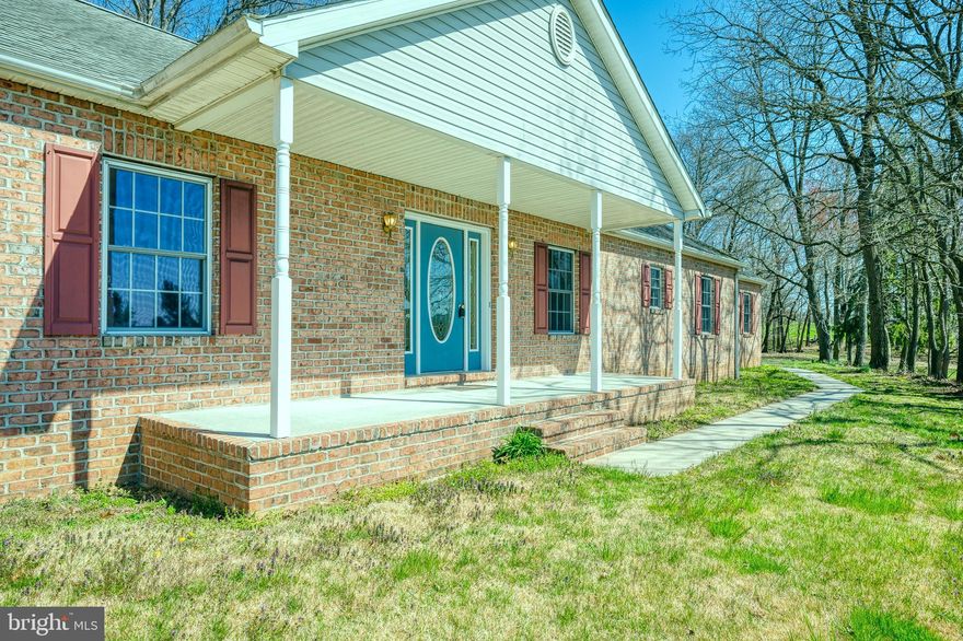 Welcome to 2820 Garrett Road, located in Whitehall, Maryland. This classic stone rancher with a large covered front porch and lush green lawns is surrounded by beautiful countryside. As you enter the home, the open spacious foyer with gleaming laminate floors and a coat closet greets you. Opening into the formal living room or formal dining room, both feature gleaming laminate floors and an abundance of natural light. The open kitchen, breakfast area, and family room with a wood-burning fireplace are perfect for entertaining. The kitchen features electric appliances, a large pantry, a breakfast bar peninsula, and table space. The main floor laundry/mud room with a separate outdoor entrance is just a bonus. The primary bedroom features a full bath with a shower stall, dual vanities, and a spacious closet. The additional two bedrooms and full bath complete the main level. The lower level is a blank canvas and ready for you to create the perfect space to meet your needs. The attic is floored and offers plenty of storage space. Outdoors you will find a large garage/shed in addition to the attached 2-car side loading garage. All this is situated on 6.5 acres and convenient to local breweries, wineries, creameries, farm stands, orchards, and commuter routes!
