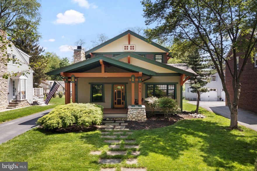 This custom-built Craftsman home, located just blocks from West Chester University and the vibrant downtown scene, blends the charm of the 1920s with modern amenities and thoughtful design throughout. Built in 2003 and meticulously maintained—including a new roof in 2023—this residence offers timeless appeal and true functionality.

Inside, the first floor features a spacious living room with custom built-ins and architectural columns, a cozy inglenook with rich woodwork and a gas fireplace, and a formal dining room that flows effortlessly into the chef-inspired kitchen. The kitchen includes high-end appliances, soapstone counters, custom period cabinetry, and a built-in banquette. A convenient mudroom  leads to the covered carport—and even includes a dog door, providing pets easy access to the fenced yard and dedicated dog run.

Also on the main level is a bedroom and full bath, perfect for guests or those who prefer first-floor living.

Upstairs, you'll find two spacious bedroom suites, each with private bathrooms. The primary suite features a walk-in closet, dual walk-in shower, and period tile work. The guest suite includes a large closet and a charming full bath with a pedestal sink and cast-iron built-in tub.

The finished lower level is ideal for entertaining or relaxing, with a home theater setup, vented gas fireplace, built-ins, and plenty of storage and workspace. A 500-gallon owned and buried propane tank supports efficient utilities, including the heating system and fireplaces.

Enjoy outdoor living on the expansive front porch finished in Trex® decking, complete with stone columns, tile insets, and an oak swing. The backyard offers a dedicated grilling station, dog run, and low-maintenance landscaping—perfect for entertaining and pet lovers alike.

With plenty of off-street parking spaces, classic craftsmanship, and modern comfort throughout, this one-of-a-kind West Chester Borough home offers an unmatched lifestyle in an unbeatable location.