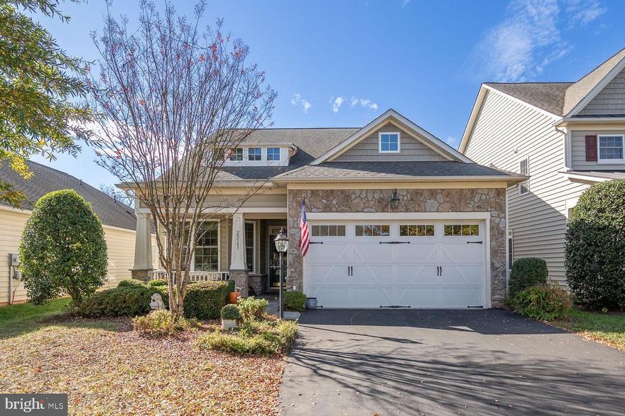 Welcome to your new home in Potomac Green - Ashburn's premier 55+ living community. This lovely Powell model with loft features 2 bedrooms/2 baths on main level, plus a 3rd bedroom and full bath on upper level.  Gleaming hardwood floors great you at the front door, office/study in front of home has views of the front porch and beautiful landscaped front yard.  Large, light and bright dining room.  Enjoy your kitchen, cooking on the gas cooktop, double ovens, cozy breakfast area w/bay window and a pantry.  The family room boast a vaulted ceiling and lots of light from multiple windows - Remote control blinds in family room and breakfast area.  From the family room you have access to the gorgeous extended patio to enjoy the views of common area and trees.  Two awnings provide you shade.  In the private  primary bedroom, you will enjoy views of the back yard, plus outside cooling shades on back windows,  two walk-in closets, new carpet.  The gorgeous updated primary bath features newer lighting, 2 sinks, cabinet w/quartz counter top, soaking tub, glass enclosed quartz shower w/lighting, quartz floors.  Main level second bedroom with new carpet and updated 2nd bath. Freshly painted.  Laundry/ room w/utility sink and access to a garage with tile floor.  Garage storage units and television convey.  The upper level loft overlooks living area.  3rd bedroom and full bath are perfect for guests.  Enjoy Potomac Green activities and amenities including state of art fitness center, indoor & outdoor pools, indoor walking track, meeting rooms, game rooms, library, community walking trails, sports courts, plus much more.  Easy access to major roads (Rt 7, Rt 28, Dulles Greenway). Silver Line metro station and Washington Dulles International Airport nearby.  Convenient to restaurants, shopping, movie theater, hospital, One Loudoun & the Ashburn Senior Center.  Great Place to call home!!