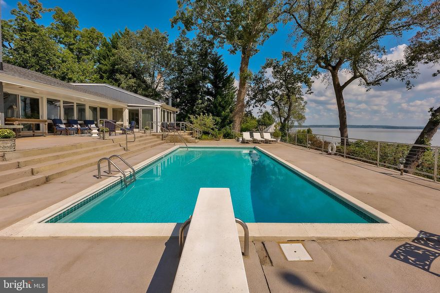 City Close but Country Quiet... Wonderful one level living on the Potomac River in one of Mount Vernon's most sought after enclaves... Belle Rive.  This home has been expanded and updated with every feature one may be looking for... flooring,  appliances, doors and windows are all top of the line selections and all built-ins and special accents were created by the area's best craftsmen.  One enters through an expansive foyer that opens into a 20 X 27 great room with unparalleled views up and down river... views which are protected by easement so your view of the other shore will remain as it did when George Washington lived next door.  And you also have a front row seat to all the fireworks displays at Mount Vernon all year. 
 Great room boasts an oversized gas fireplace and is naturally illuminated by a full wall of windows facing the river and also sunlit by transoms running the length of the room on the opposite wall.  The room opens into a TRUE Chef's kitchen with every imaginable hot button kitchen item a Chef desires and requires.  Anchored by a five by eight marble island, appliances are by Kitchenaid and Frigidaire and include a 6 burner gas cooktop, double wall ovens, 2 dishwashers, ice maker, and wine cooler.  Accented by marble backsplashes that coordinate with the island there is also an additional prep sink and large walk-in pantry PLUS an adjacent home office nook.   Formal dining room has vaulted ceiling with built-ins galore and opens onto pool terraces via oversized sliding glass doors as does the great room, master suite, and guest suite.  Master Suite is accessed by large cross hall that also functions as a home library with 18 feet of linear shelving perfect for books or to display art as it is lit by eyeball lights.  Master suite echoes the great room in volume and also has vaulted ceiling and a wall of glass overlooking the Potomac.  It has not one but two dressing rooms with sumptuous his & her baths.  This South Wing of the house also has an oversized laundry space along with second foyer at the garage entrance.  The North Wing boasts two more bedrooms, each with an ante room for study or home office work, as well as massive five by seven closets and private baths.  The Guest Suite with fireplace has a wall of windows overlooking the Potomac similar to that of the Master Suite and also opens onto the pool terraces.  Living space is extended outdoors by extensive terraces that encircle the inground pool, the smallest of which measures 9 X 12.  And the pool terrace has wonderful nautical railings that enhance the relaxing waterfront lifestyle while also minimizing any disruption to the view from the interior of the house.  Extensive professionally landscaped grounds with specimen plantings and rare flowering shrubs.  Plus the pleasure of living in a virtual bird sanctuary... Eagles, Heron... all abound right on the premises.   Private dock AND boat lift. 
 Agents say it all the time... But it's true.... This is a ONE OF A KIND property.