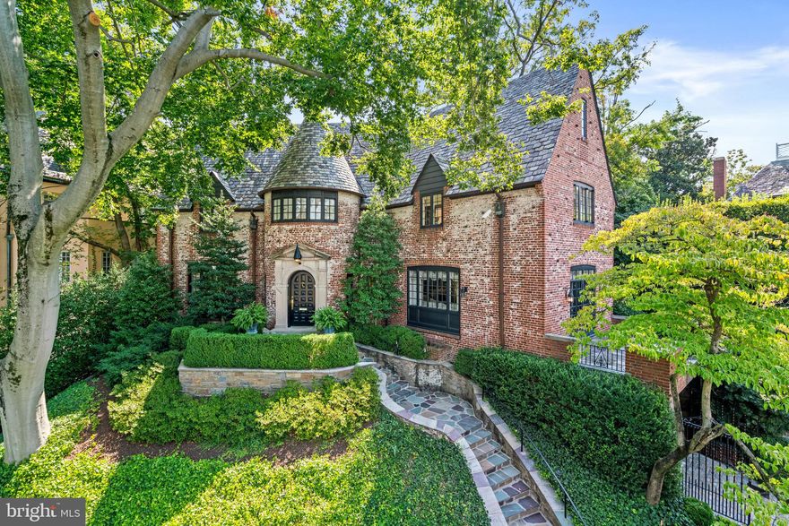 This exquisite property represents a rare opportunity to own a piece of architectural history, meticulously enhanced with the highest quality renovations, in one of the most prestigious neighborhoods in the city—truly a remarkable value in luxury and legacy. Perfectly positioned among the elite homes of Kalorama, this residence is the embodiment of revival-style architecture at its most refined. Inspired by the charm of Normandy and the grandeur of English country estates designed by Sir Edwin Lutyens, it beautifully merges steep, conical roofs with an asymmetrical layout. Recently updated through a multi-year renovation to meet the highest standards of quality, each enhancement preserves the unique architectural heritage while introducing modern comforts and efficiency. Crafted by the acclaimed architect John J. Whelan, known for his bespoke designs of luxurious homes and embassy residences, this property stands majestically, offering panoramic views of the National Cathedral and the cityscape. Originally constructed in 1927 and enveloped in Scottish brick bond, this home has undergone a meticulous renovation while retaining its historic allure, complete with towering chimneys and an authentic slate roof. Beyond its exterior, the interior exudes sophistication, with a welcoming foyer leading to a spacious living room, adorned with a fireplace and balcony. There is a sophisticated dining room and a recently updated gourmet kitchen with spectacular Clive Christian cabinetry, Imperial Danby marble surfaces and floors, and top-of-the-line appliances including Viking and Subzero. There is also a convenient butler’s pantry off the kitchen for additional storage needs. The family space seamlessly integrates indoor and outdoor living, with French doors leading to a private terrace surrounded by lush landscaping, which is perfect for entertaining. The second floor offers an expansive primary suite with two attached, luxurious bathrooms. The walls are sumptuously upholstered in Cowtan & Tout silk and include trim by Farrow & Ball.  The bathrooms are clad in marble, complemented with Waterworks fixtures, and finished with the finest materials.  There is also an additional bedroom, a guest bedroom/study with a dressing room, and an updated full bathroom found on this floor. The third level offers two more bedrooms, an office, and an oversized storage room with ample built-ins. Further amenities include a fully equipped lower level, boasting a Sonos home-theater lounge, garage, and laundry room, as well as modern conveniences like three-zone HVAC and a comprehensive security system. Kalorama is close to Georgetown, Rock Creek Park, museums, the Kennedy Center, downtown DC, and Reagan National Airport. The house’s prestigious location not only ensures a distinguished provenance but also places it in a neighborhood renowned for its historic significance and exclusivity, which has been home to past presidents, dignitaries, and embassies for over 100 years. This residence offers a lifestyle of unparalleled elegance and convenience, making this home a prized possession and a rare opportunity.