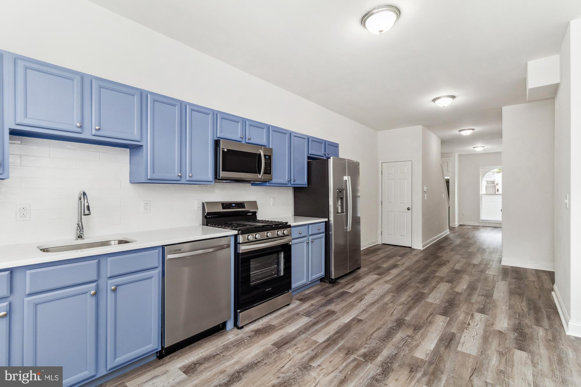 Home is eligible for grants such as buy back the block (give up to 20K to eligible buyers). Discover the charm of Baltimore City in this beautifully renovated 2024 townhome, featuring iconic marble stoops. As you step inside, you'll be greeted by luxurious vinyl plank flooring throughout the main level, an open floor plan encompassing a spacious living room and eat-in kitchen, and a convenient half bath. The kitchen boasts brand new stainless steel appliances, freshly painted cabinets, and stunning quartz countertops. Main level also has the convenience of the washer & dryer hook up. Upstairs, you'll find three bedrooms with new carpet and a full bathroom. The lower level offers a partially finished space perfect for additional living or recreation. Outside, enjoy a fully fenced yard, ideal for outdoor activities. Don’t miss your chance to call this home!