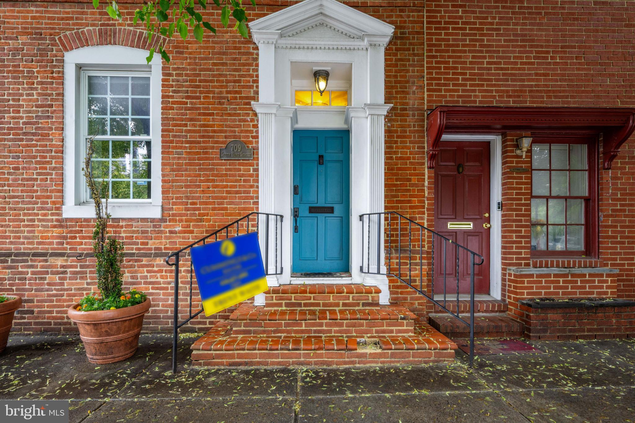 Welcome to 709 S Bond Street — a Historic Fells Point Gem Built in 1850! This is a 2 bedroom which could easily be converted into a 3 bedroom.
Step through the marble-tiled foyer and into a home that effortlessly blends historic charm with modern comforts. The main level features hardwood floors and a sunlit living room complete with an elegant electric fireplace. French doors open into the formal dining room, also adorned with an electric fireplace — perfect for intimate gatherings.
Continue into the inviting family room, where a cozy wood-burning fireplace sets the mood. The adjacent gourmet eat-in kitchen boasts stainless steel appliances, granite countertops, and ample cabinetry. From here, walk out onto your private wrap-around patio — ideal for al fresco dining or entertaining guests.
Upstairs, the primary suite offers a serene retreat with a walk-in closet and a beautifully updated bath featuring a custom vanity and ceramic tile flooring. Also on the second floor is a versatile office or sitting room with hardwood floors, built-in shelving, and another wood-burning fireplace — plus access to a private deck.
The third level presents a second primary bedroom with its own en suite bath and walk-in closet, offering flexibility and comfort for guests or family members.
The finished lower level adds even more living space or 3rd bedroom, showcasing exposed stone walls, ceramic tile floors, a rough-in for a full bath, a wet bar hookup, and a working 300-bottle wine cellar — a rare find in the heart of the city.
Nestled in vibrant Fells Point, this home offers unbeatable walkability. Whether you're strolling to the waterfront, hopping on the water taxi to an O’s or Ravens game, or commuting via nearby Route 83 or I-95, the location is as convenient as it is charming. You're also just minutes from Johns Hopkins and Patterson Park.
With its thoughtful updates, expansive layout, and unbeatable location, 709 S Bond Street is a true Baltimore treasure. Come experience all it has to offer!